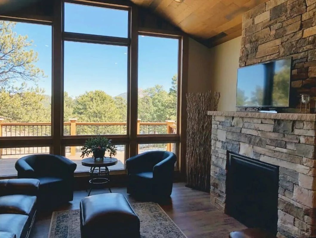 living room with large windows overlook the mountains - colorado airbnb micro wedding and elopement venue