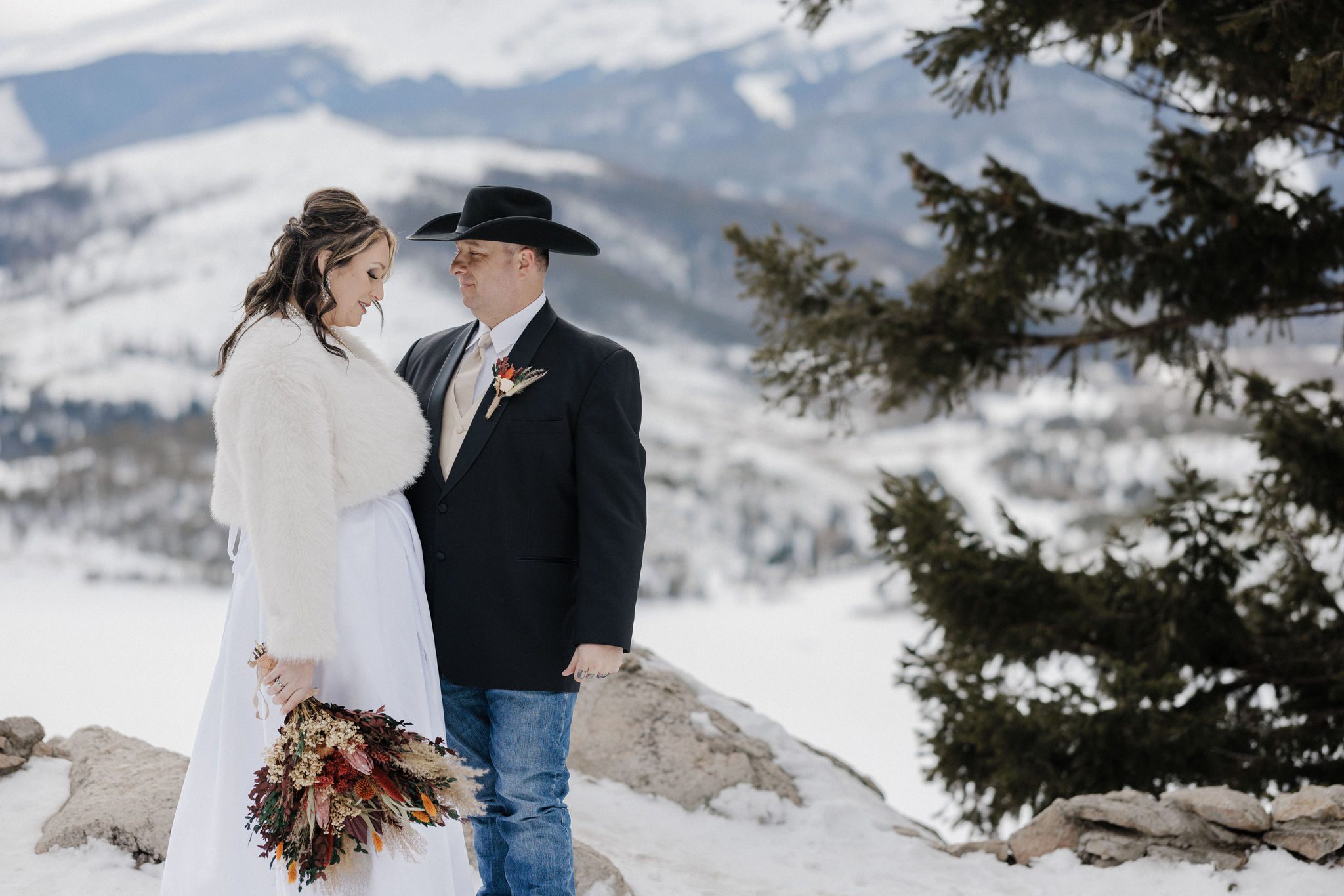 bride wears winter elopement dress and takes portraits at sapphire point overlook