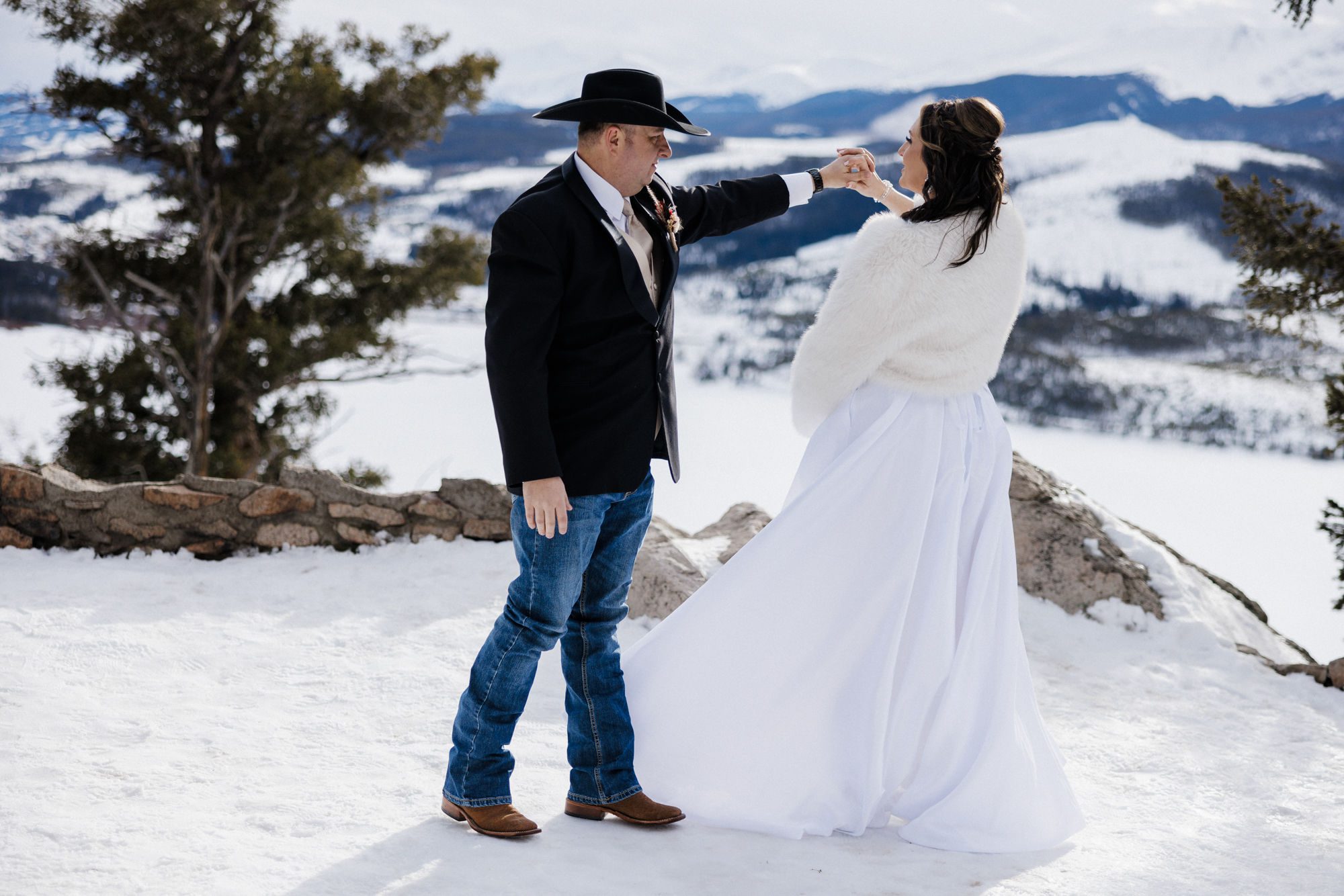 groom twirls bride during winter elopement in breckenridge