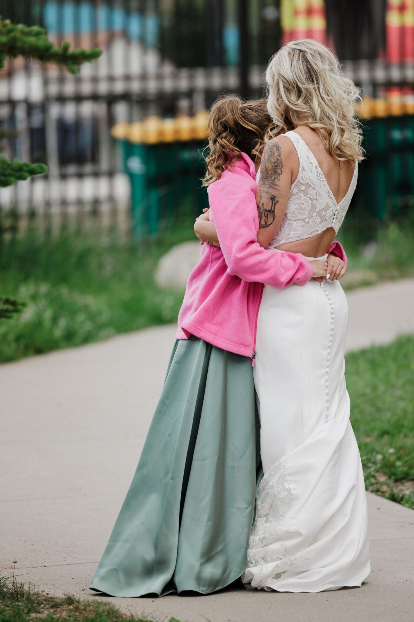 bride hugs daughter during elopement that includes her children