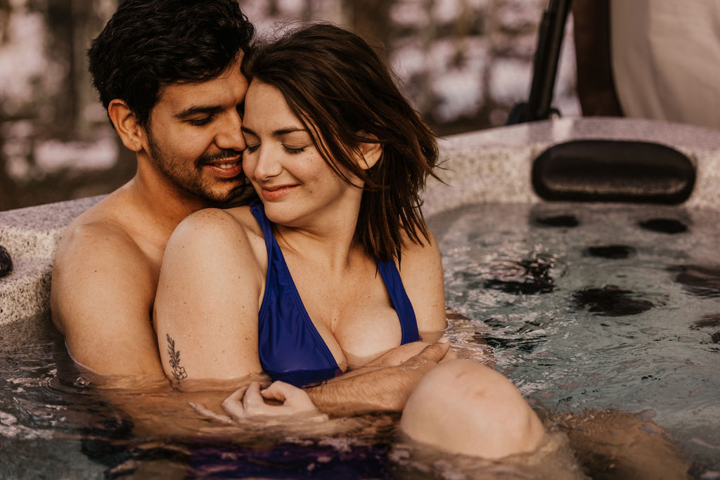 bride and groom pose for photos in hot tub during colorado winter elopement
