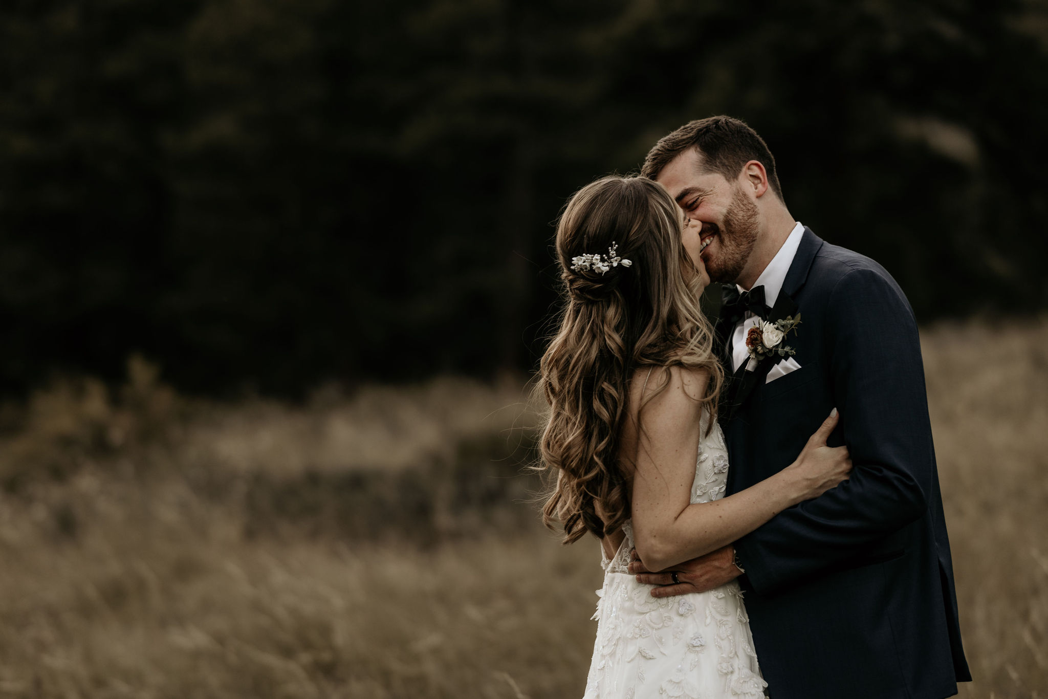 bride and groom kiss in the colorado mountains after canceling their wedding to elope.