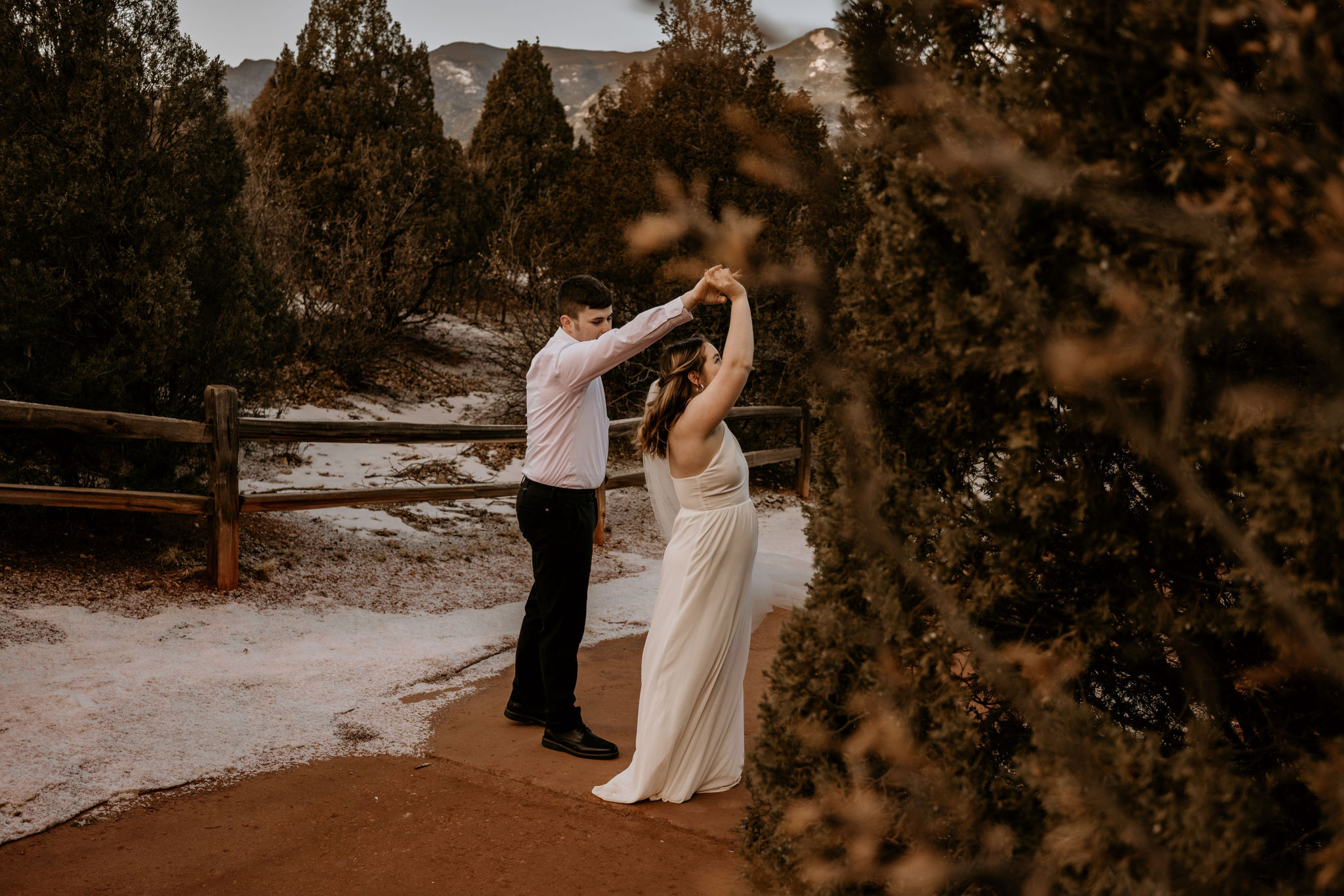 groom twirls bride during winter elopement in colorado.