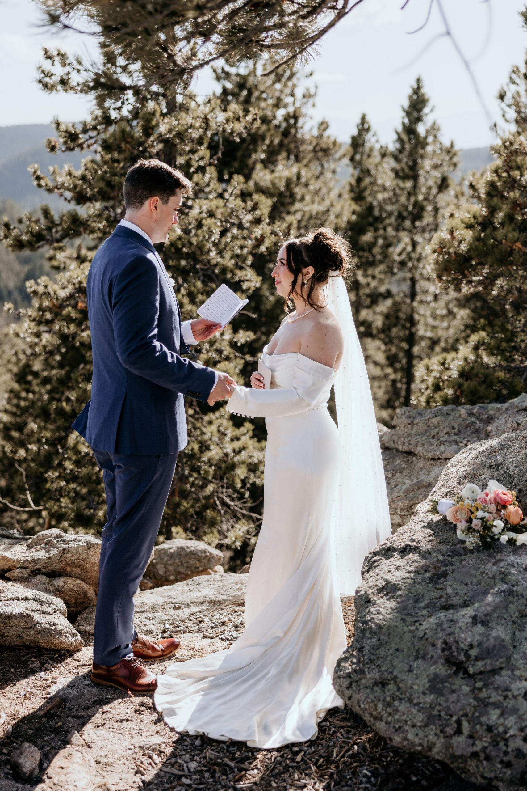 bride and groom say wedding vows in the colorado mountains after canceling their wedding to elope.