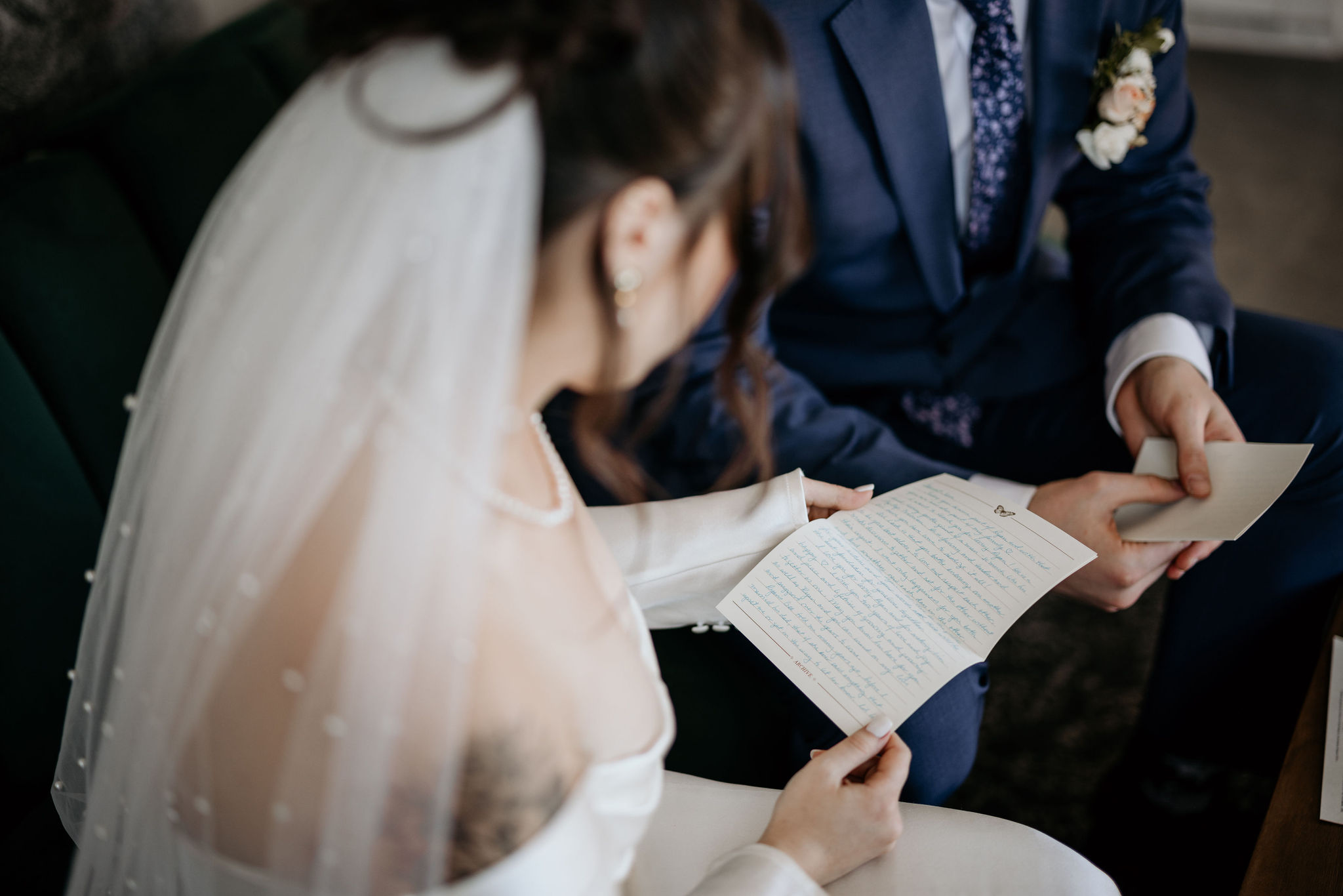 bride and groom read letters from family during colorado elopement.