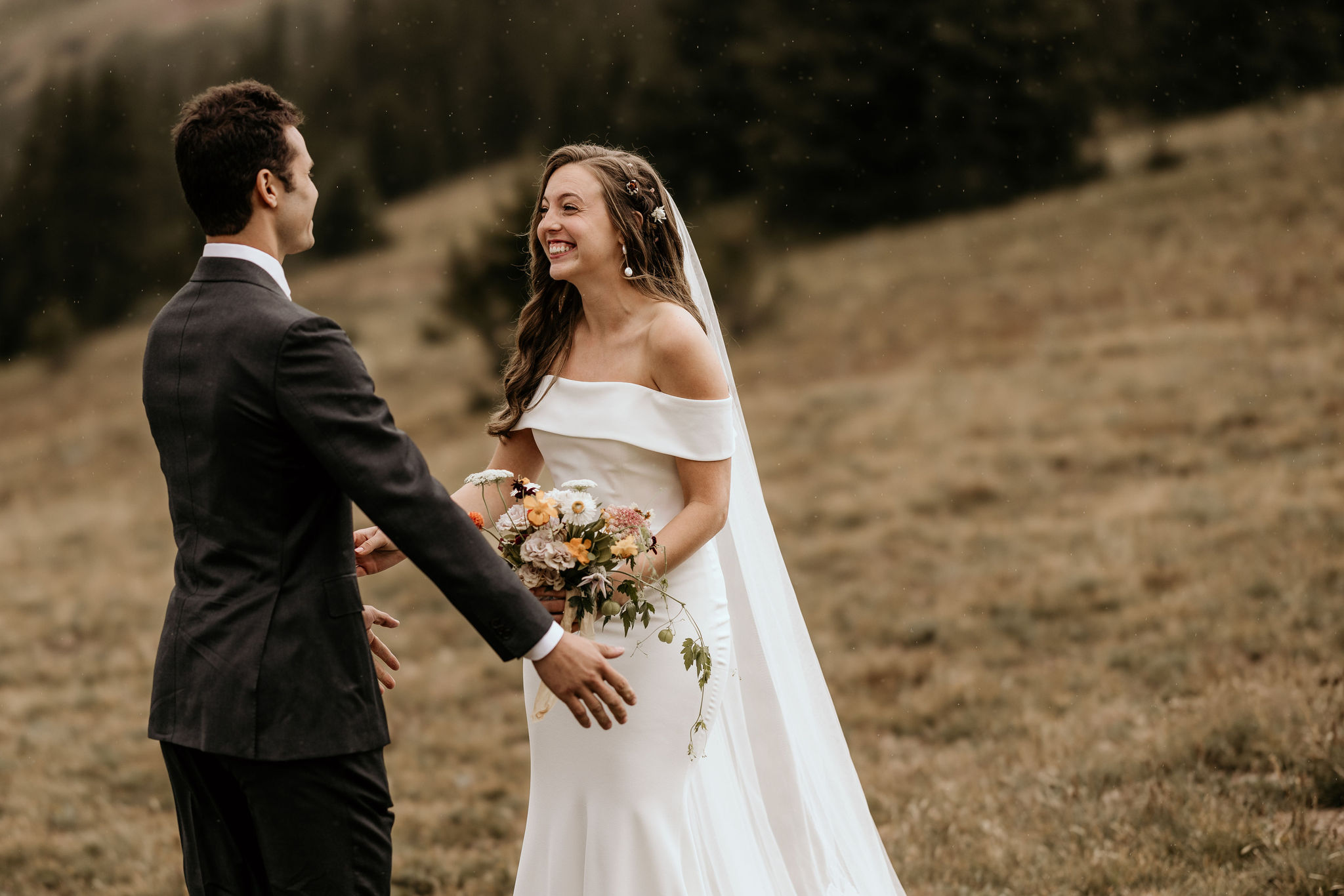 groom turns around and smiles when he sees his bride during elopement first look.