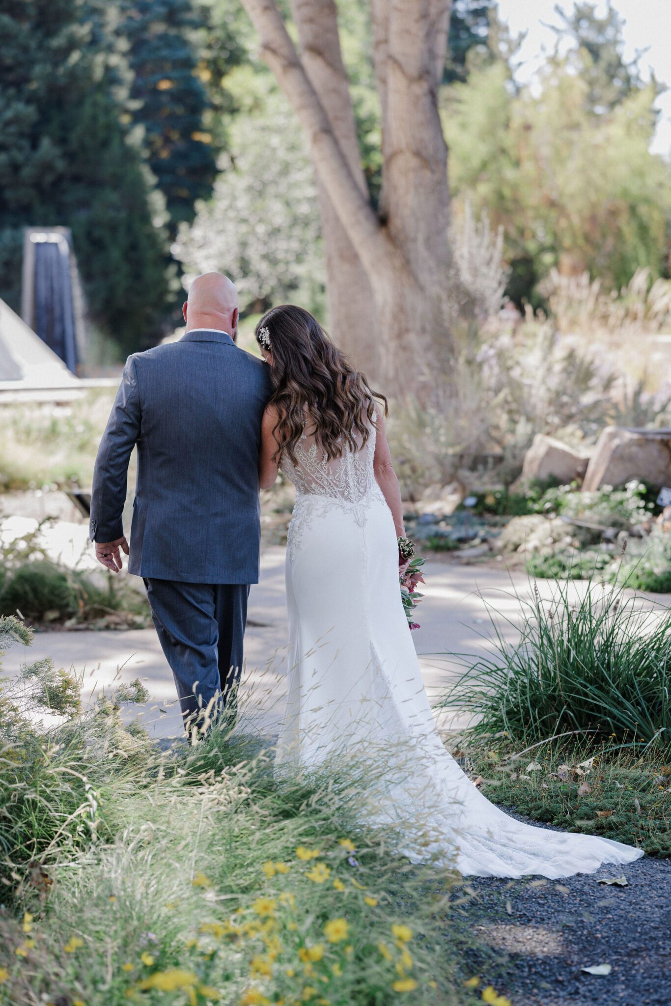 bride leans head on grooms shoulder after their second wedding