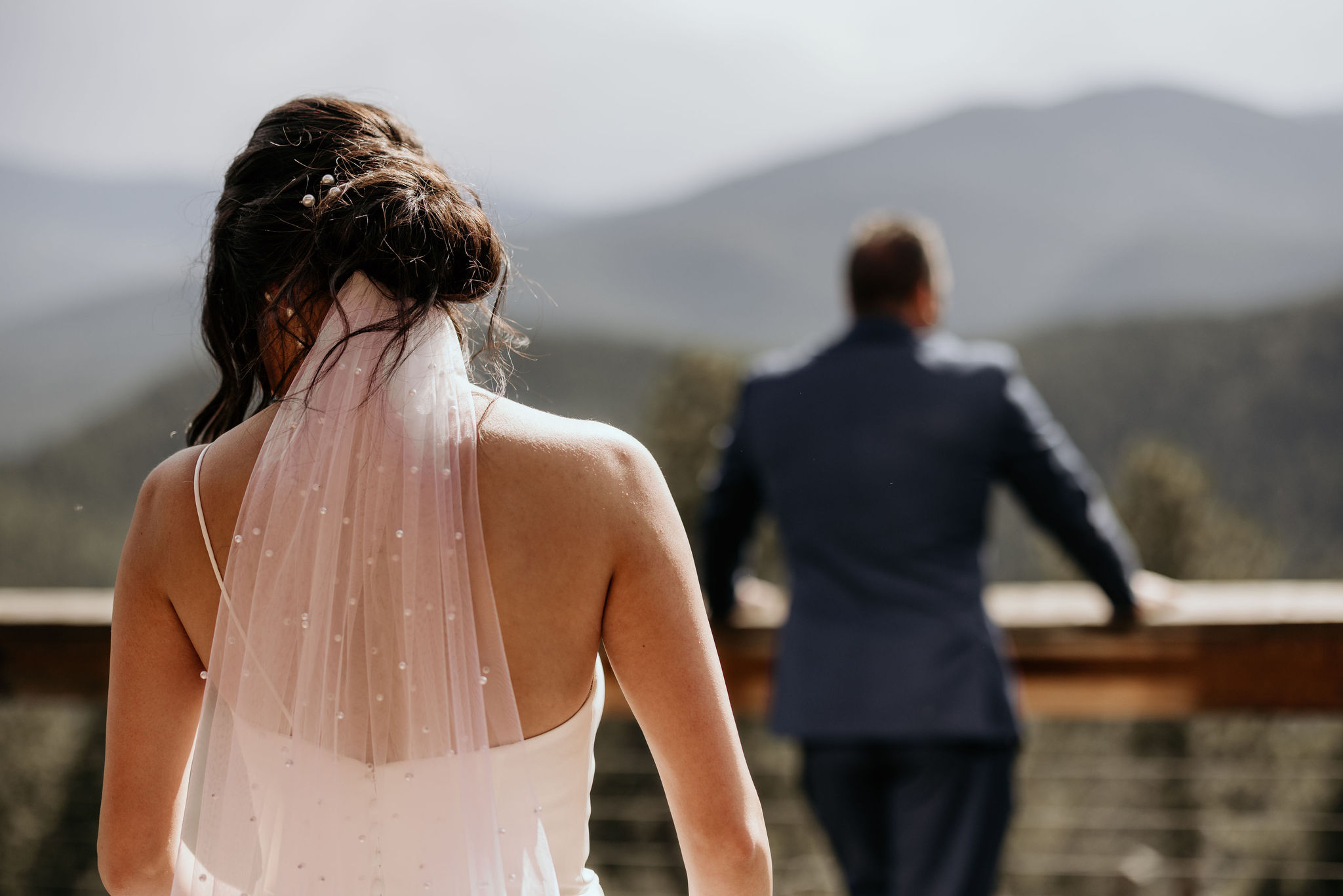 bride stands behind her father during family first look at her colorado micro wedding.
