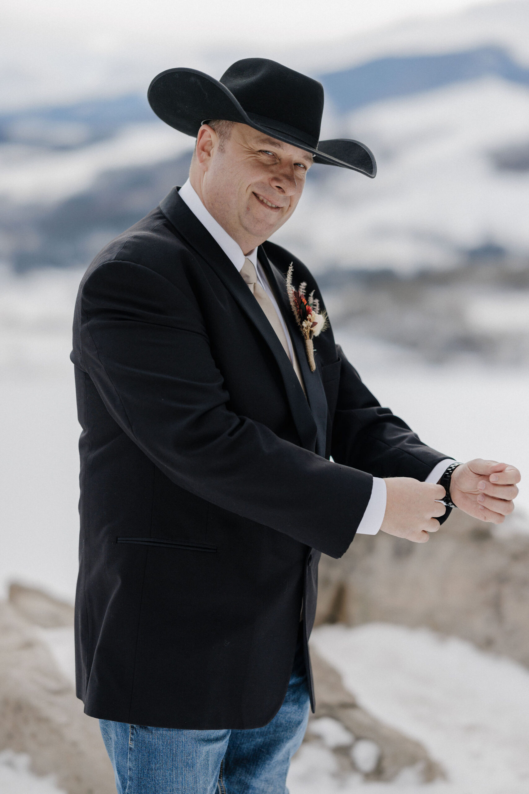 groom smiles as he gets ready for his elopement ceremony at sapphire point