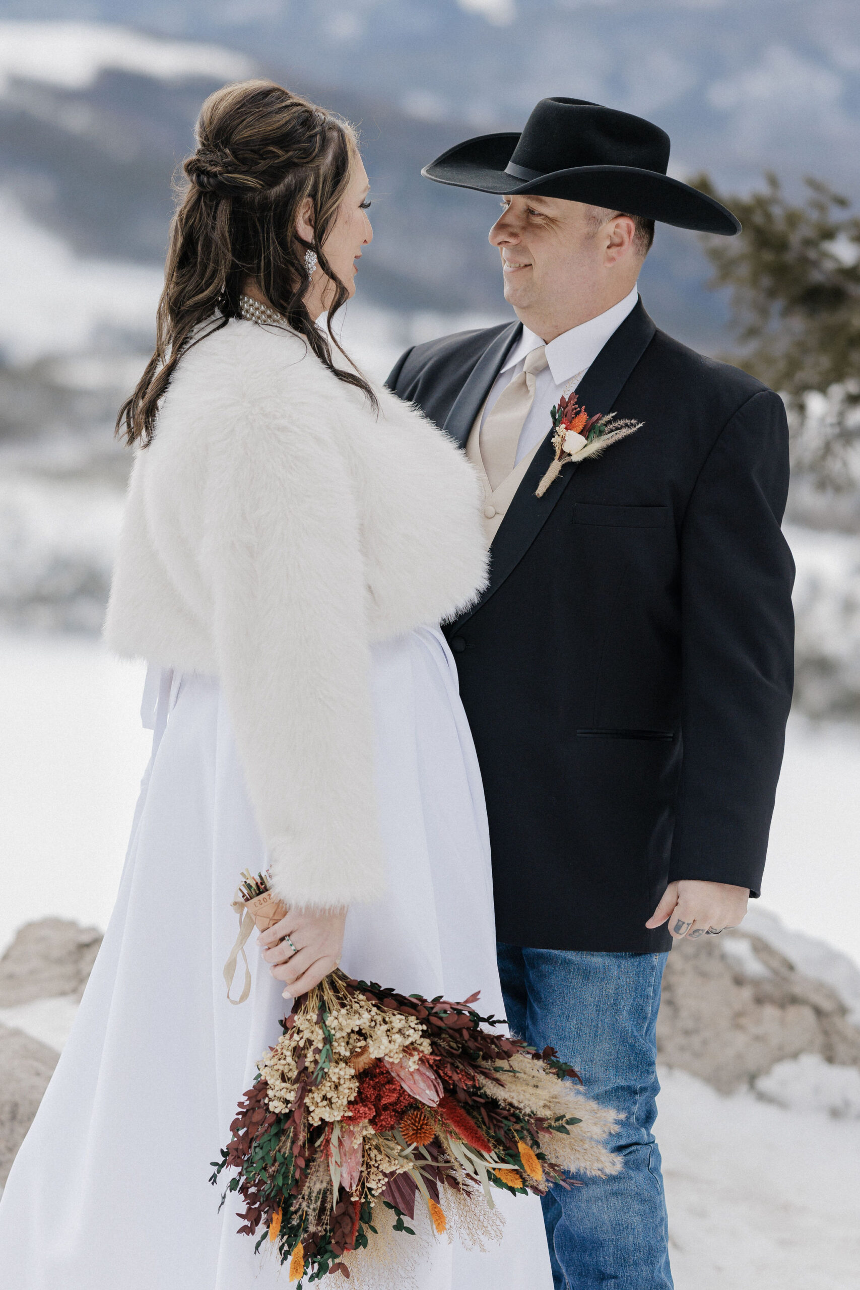 bride and groom smile at each other during sapphire point elopement photos