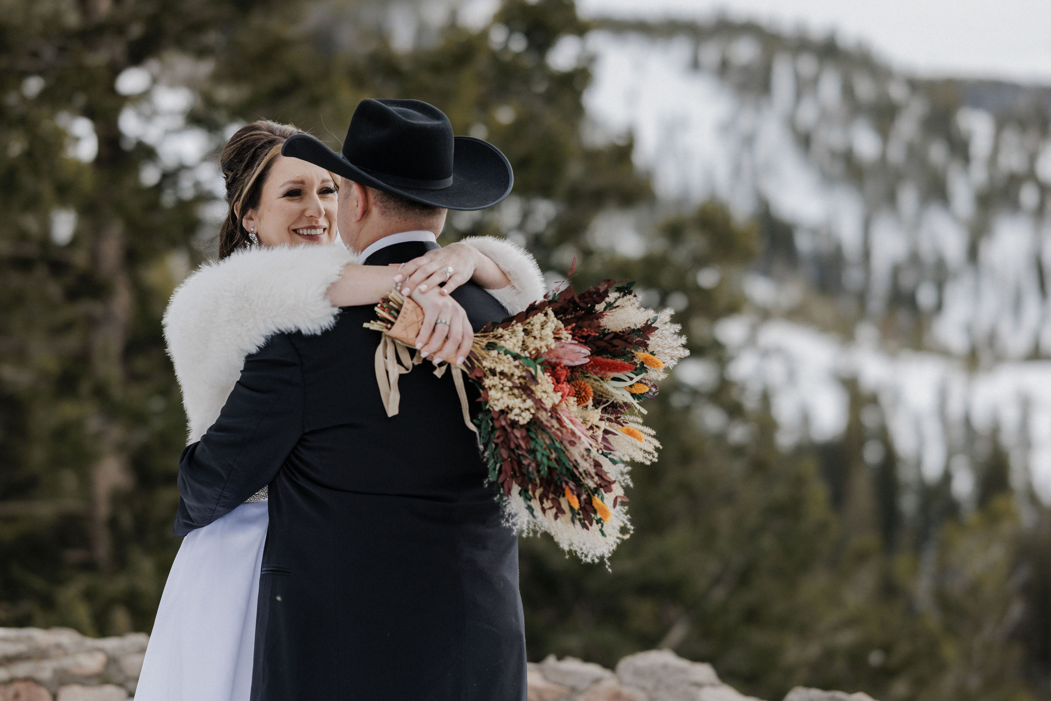 bride and groom smile at each other during colorado elopement in the mountains