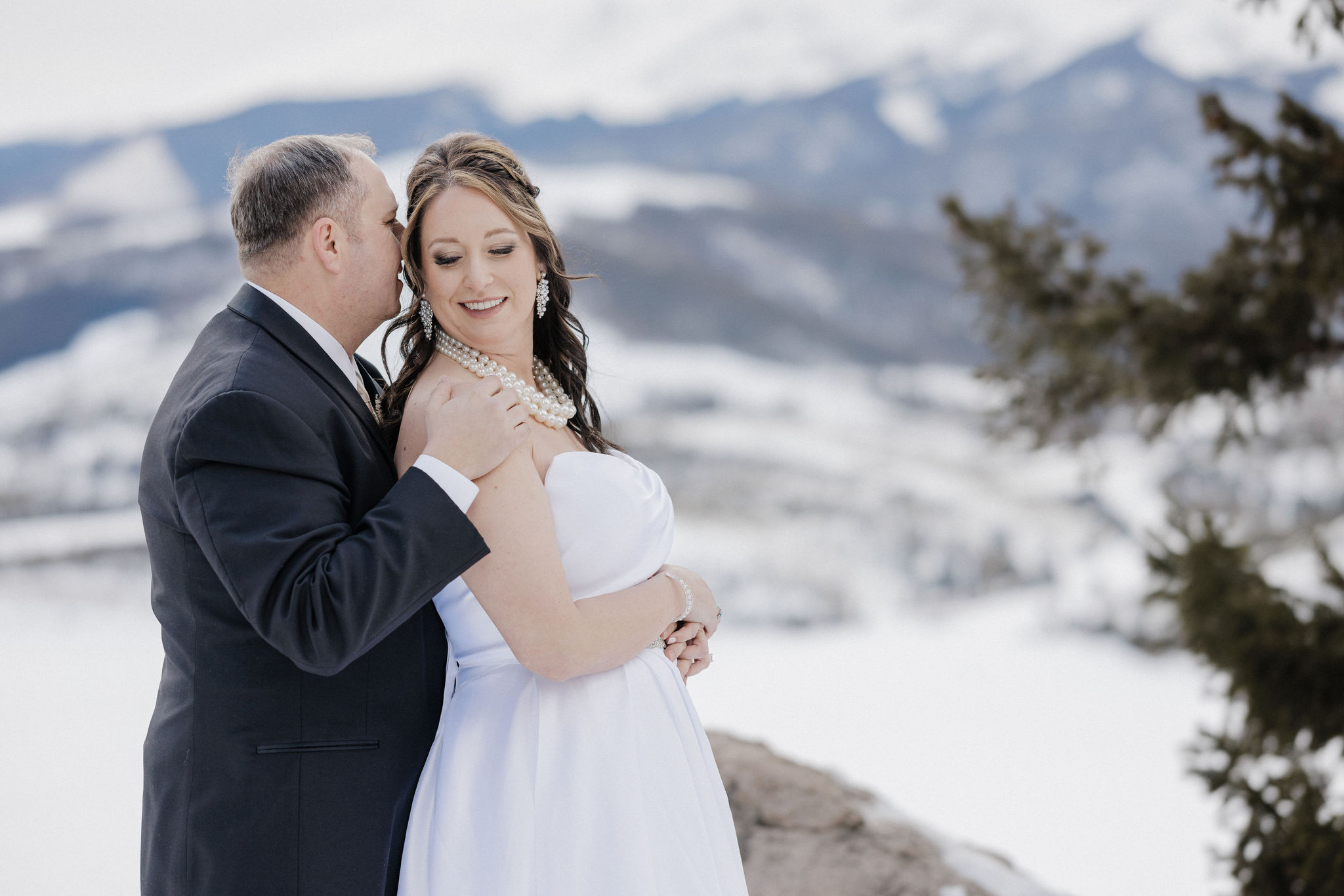 bride and groom smile during colorado elopement ceremony in the mountains