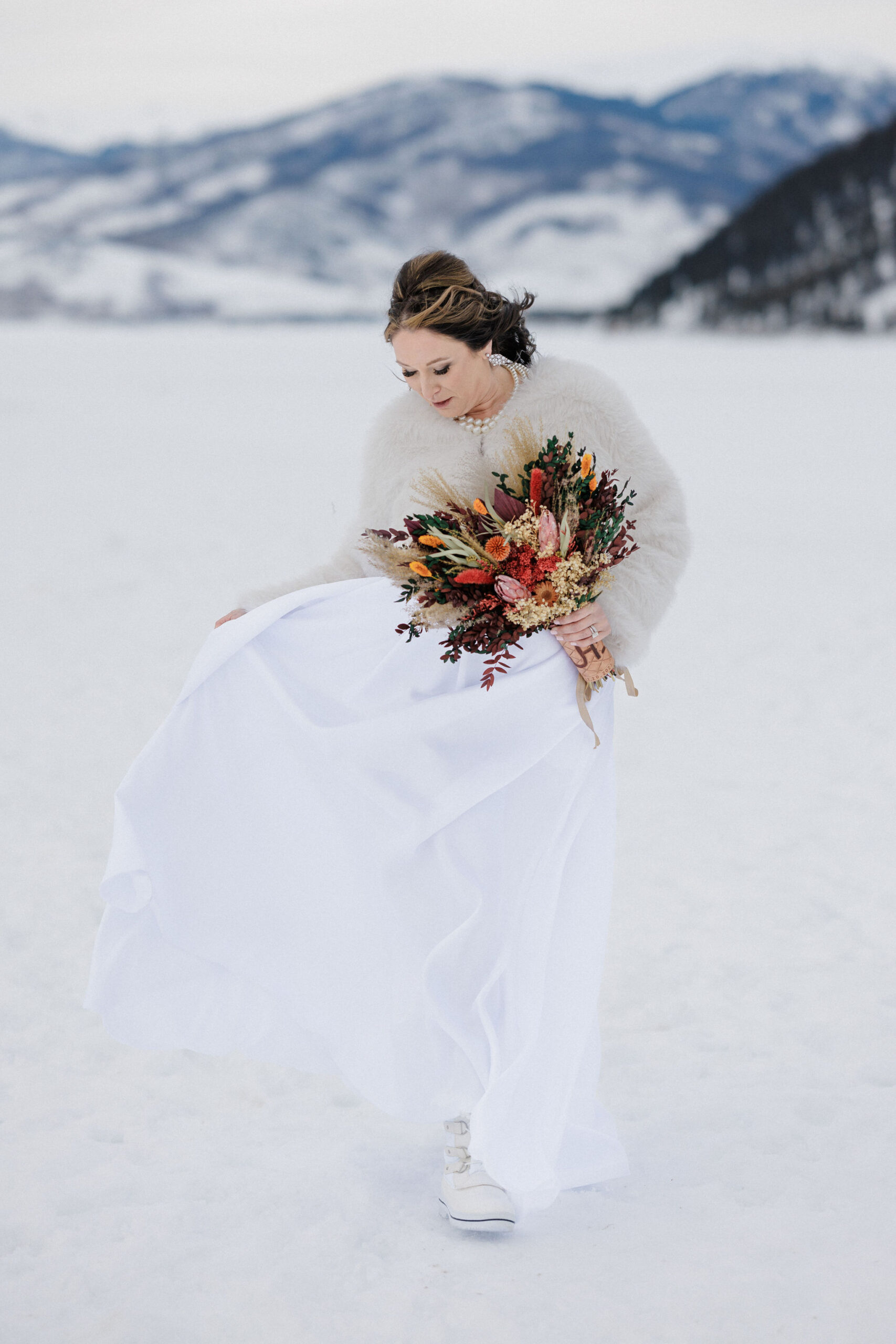 bride walks on trail near sapphire point overlook during elopement photos