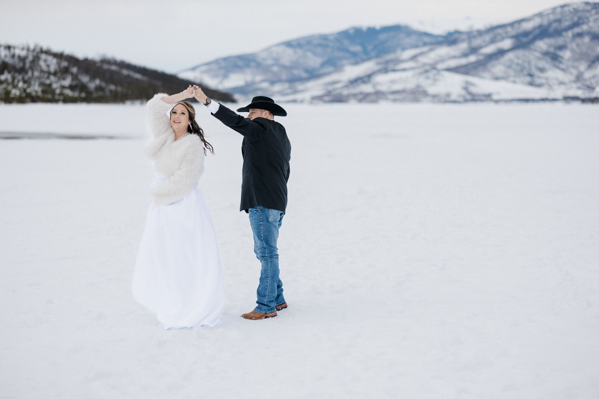 groom twirls bride in the colorado mountains during elopement day photos