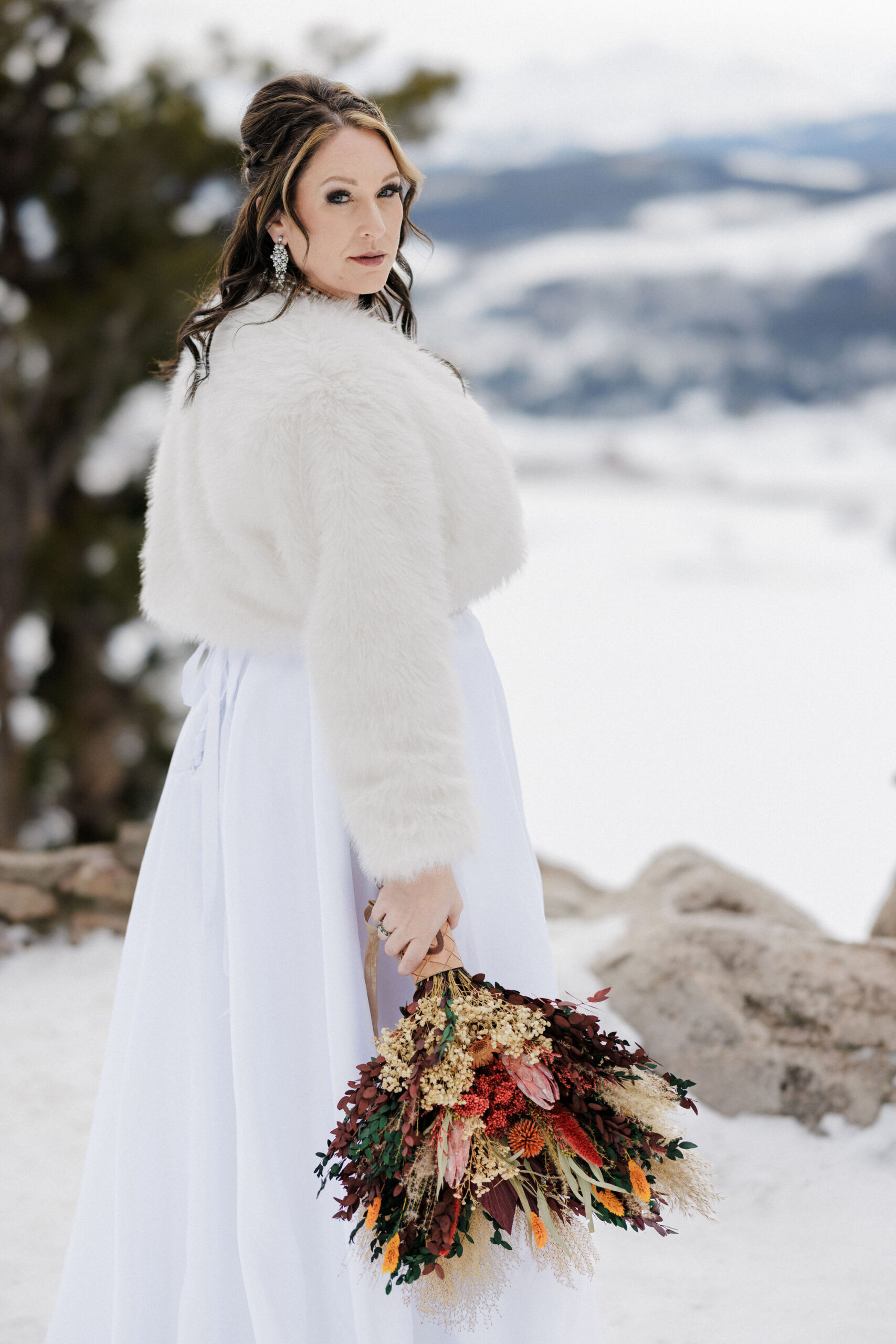 bride looks at colorado elopement photographer during wedding photos.