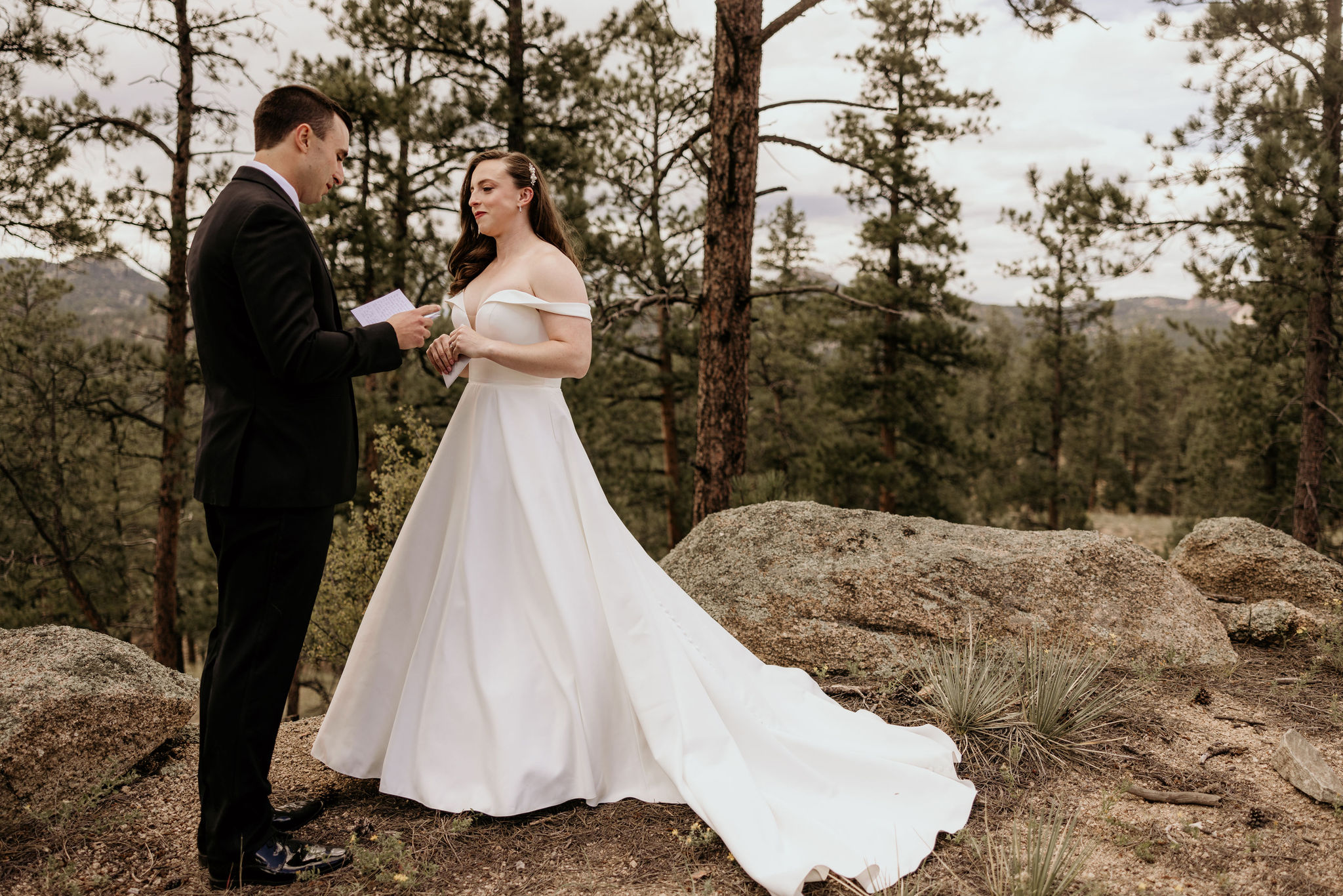 bride and groom read hand written wedding vows during self-solemnizing micro wedding in colorado.
