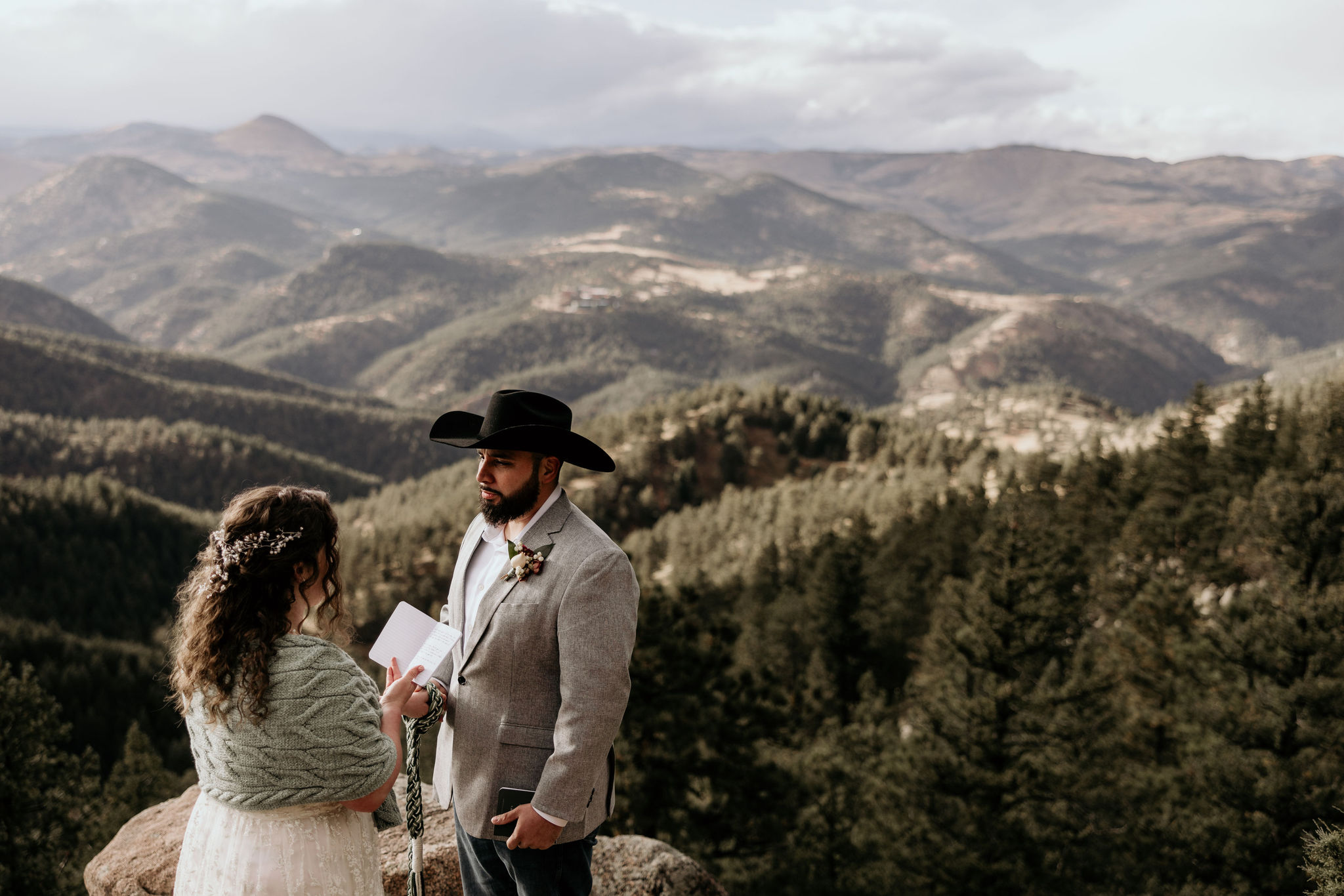 bride and groom read wedding vows during mountain elopement in colorado.