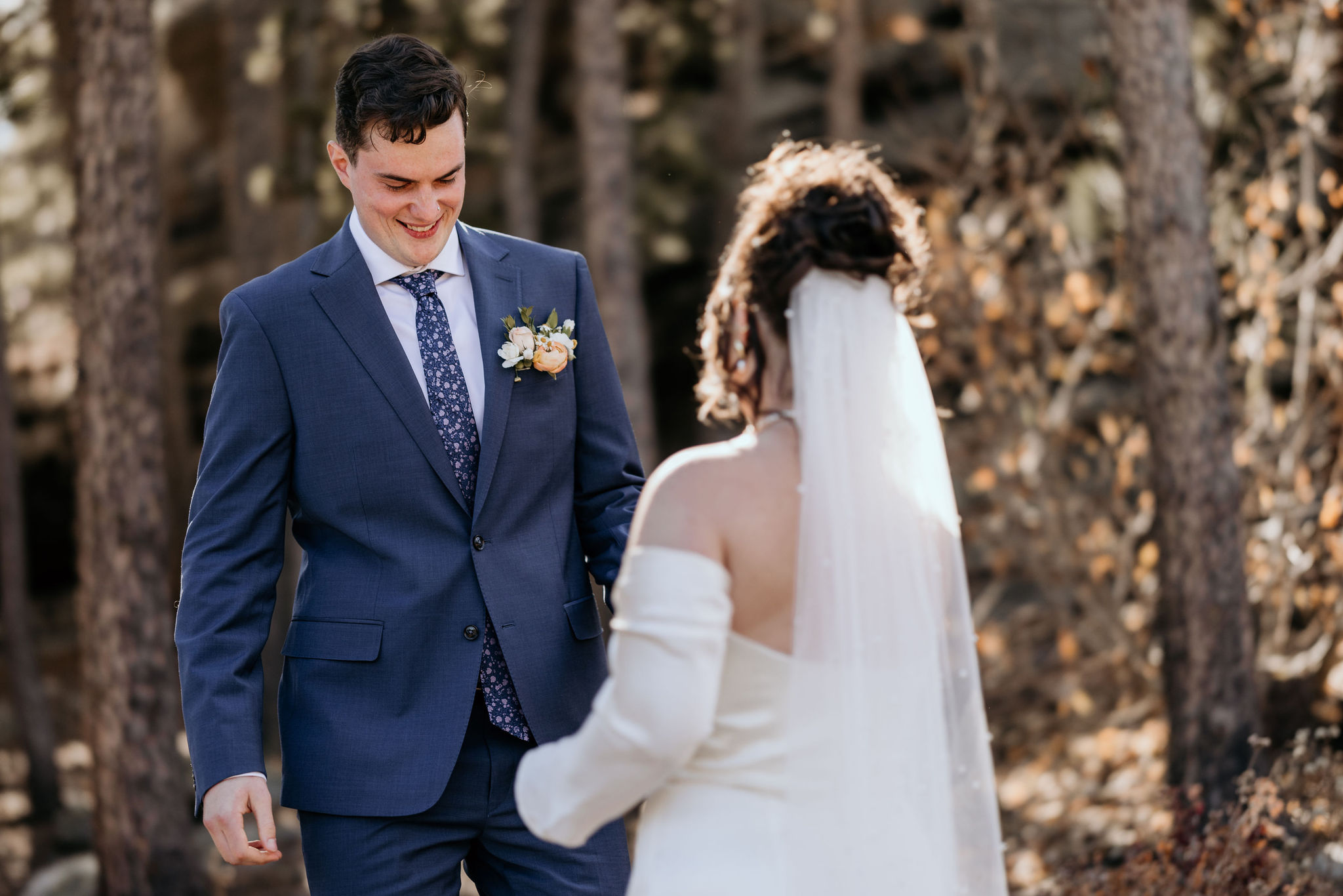 groom turns around and sees bride during colorado elopement first look