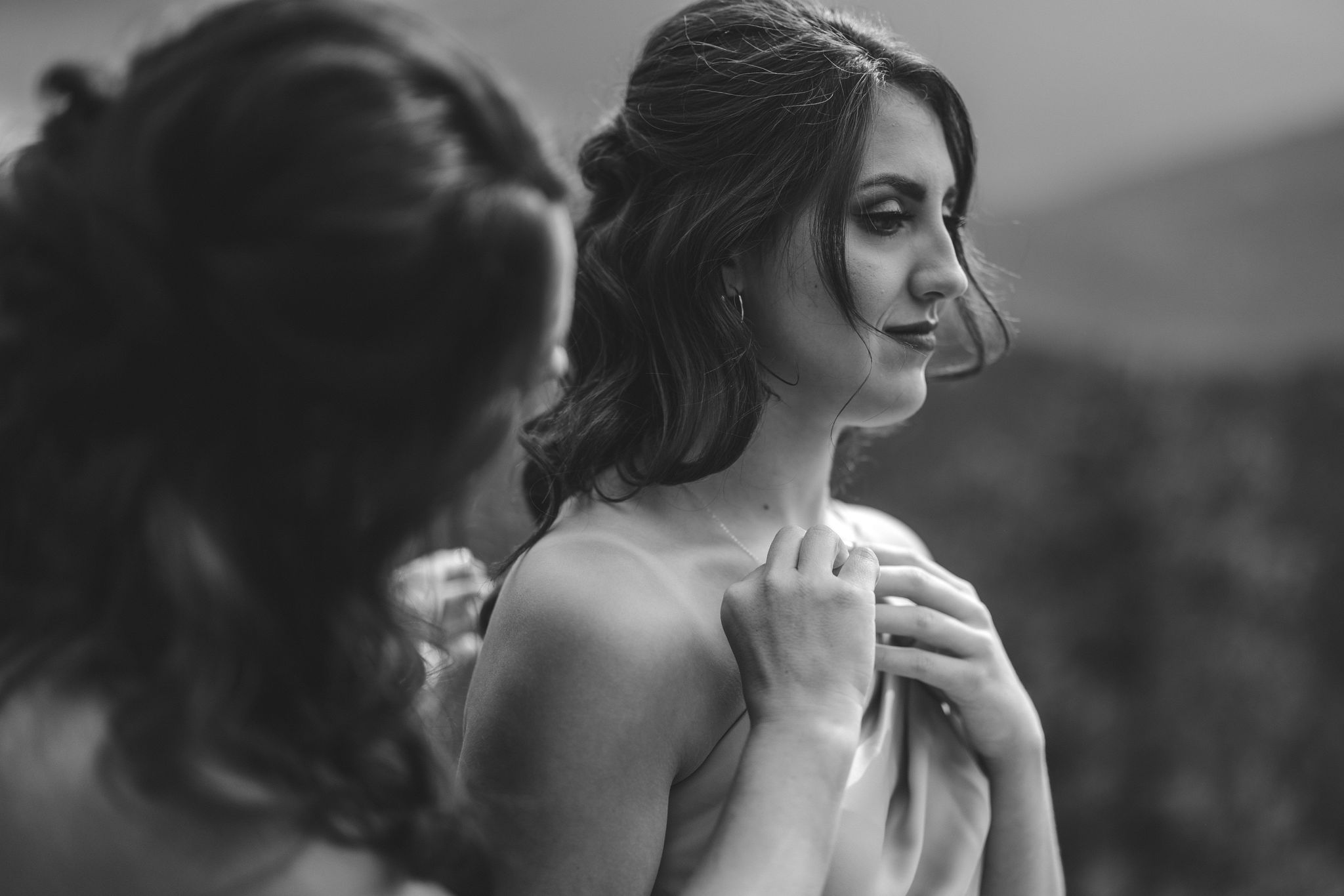 brides mother puts necklace on her during her dry wedding in colorado.