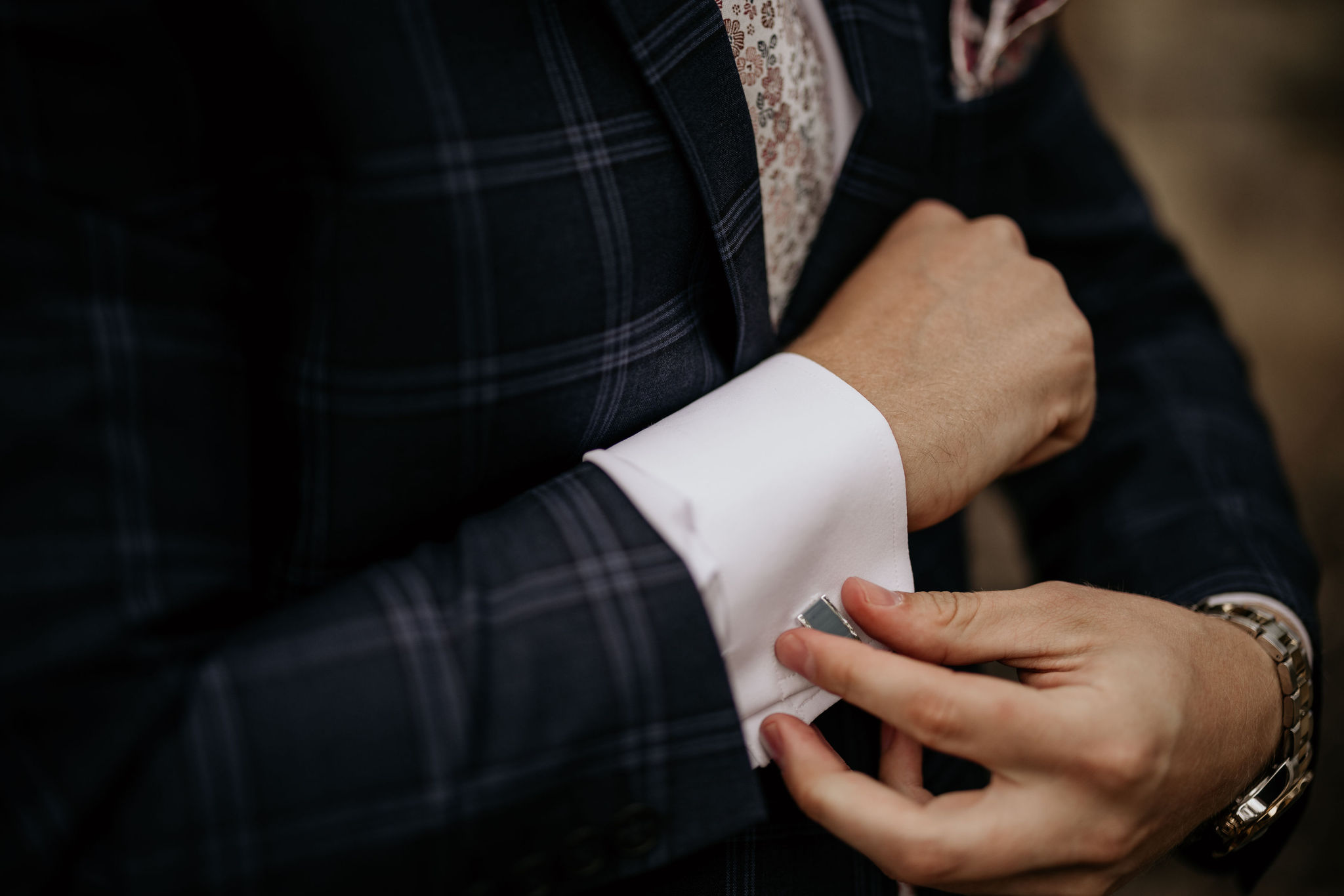 What to Pack For Your Elopement or Micro Wedding, groom puts on cufflinks for suit