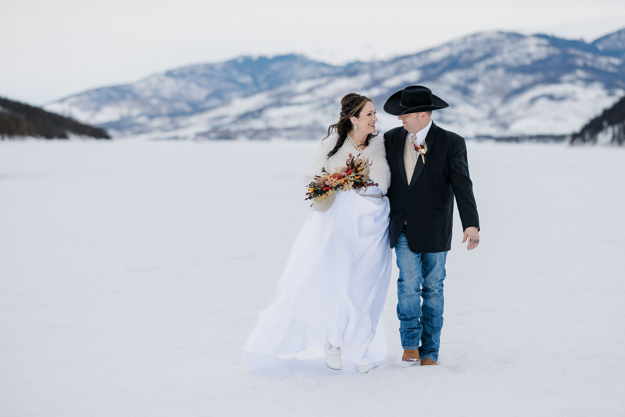 What to Pack For Your Elopement or Micro Wedding, bride and groom walk through colorado mountains