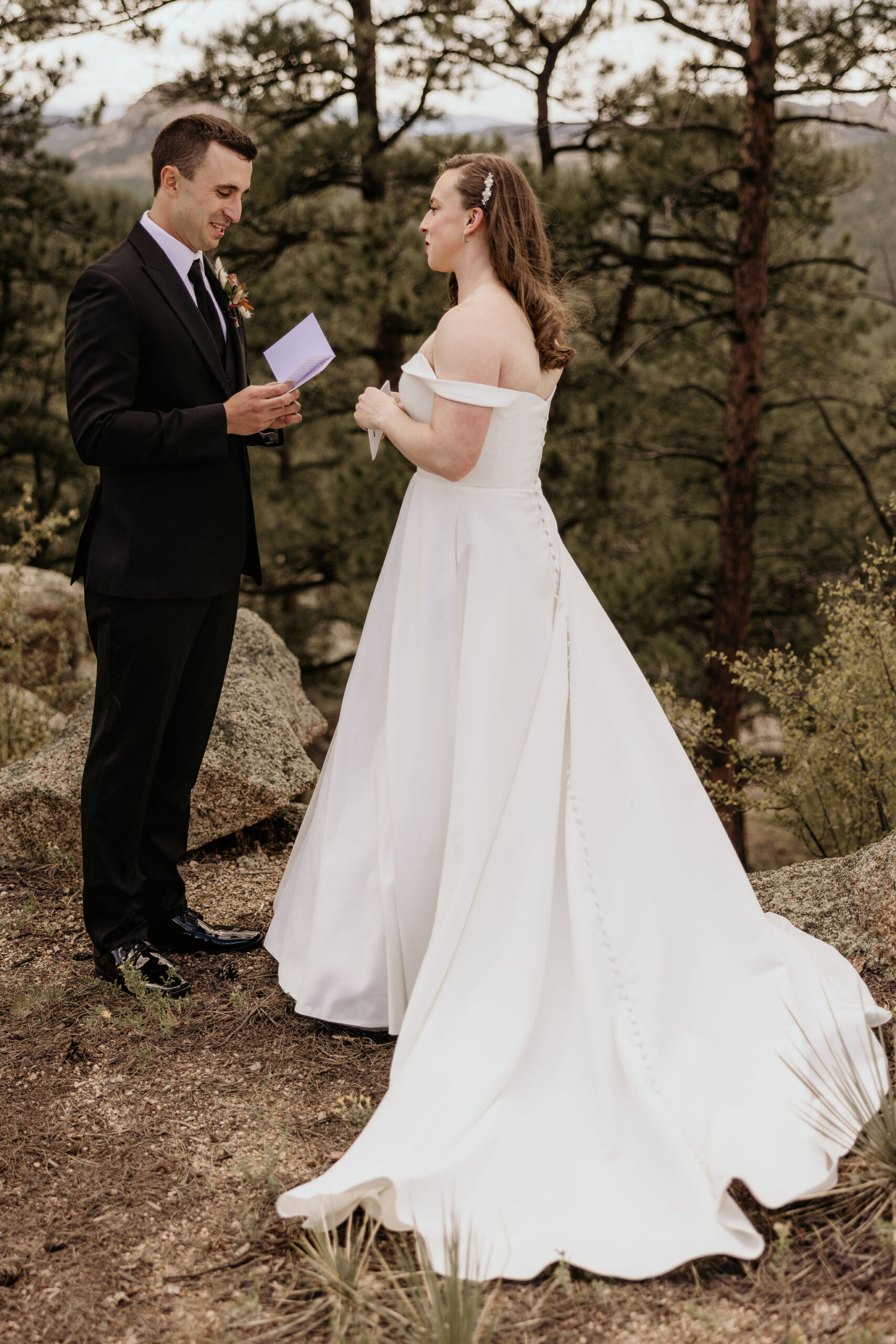 bride and groom read wedding vows during elopement day in colorado