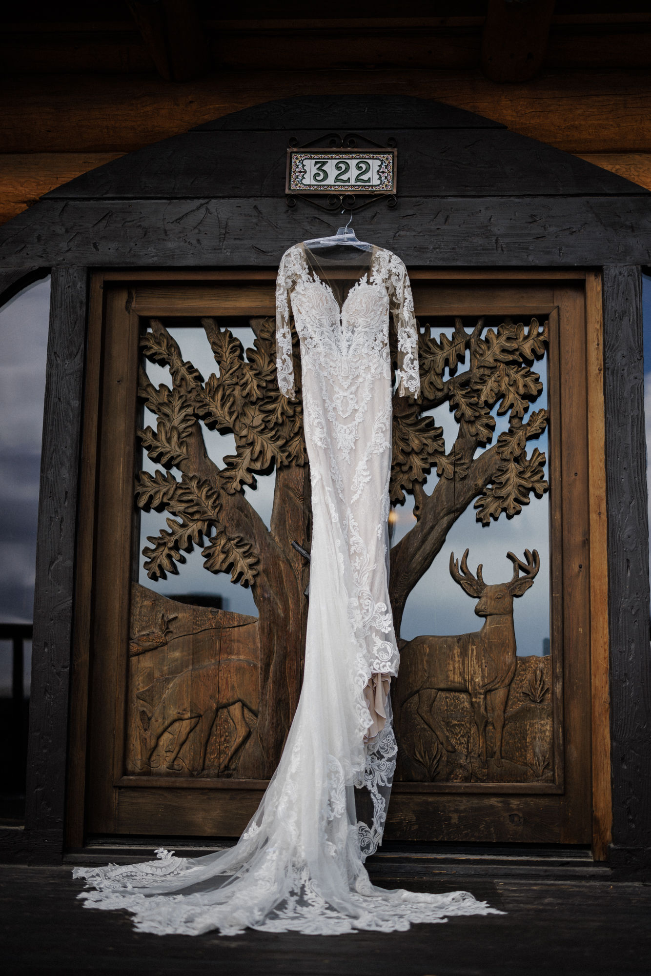 What to Pack For Your Elopement or Micro Wedding, wedding dress hangs from door at colorado airbnb