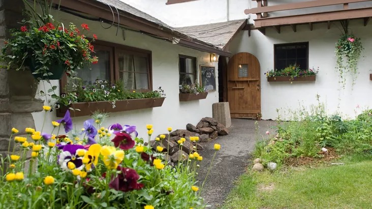 the lodging of a micro wedding venue in colorado with wildflowers and a rocky path to the door