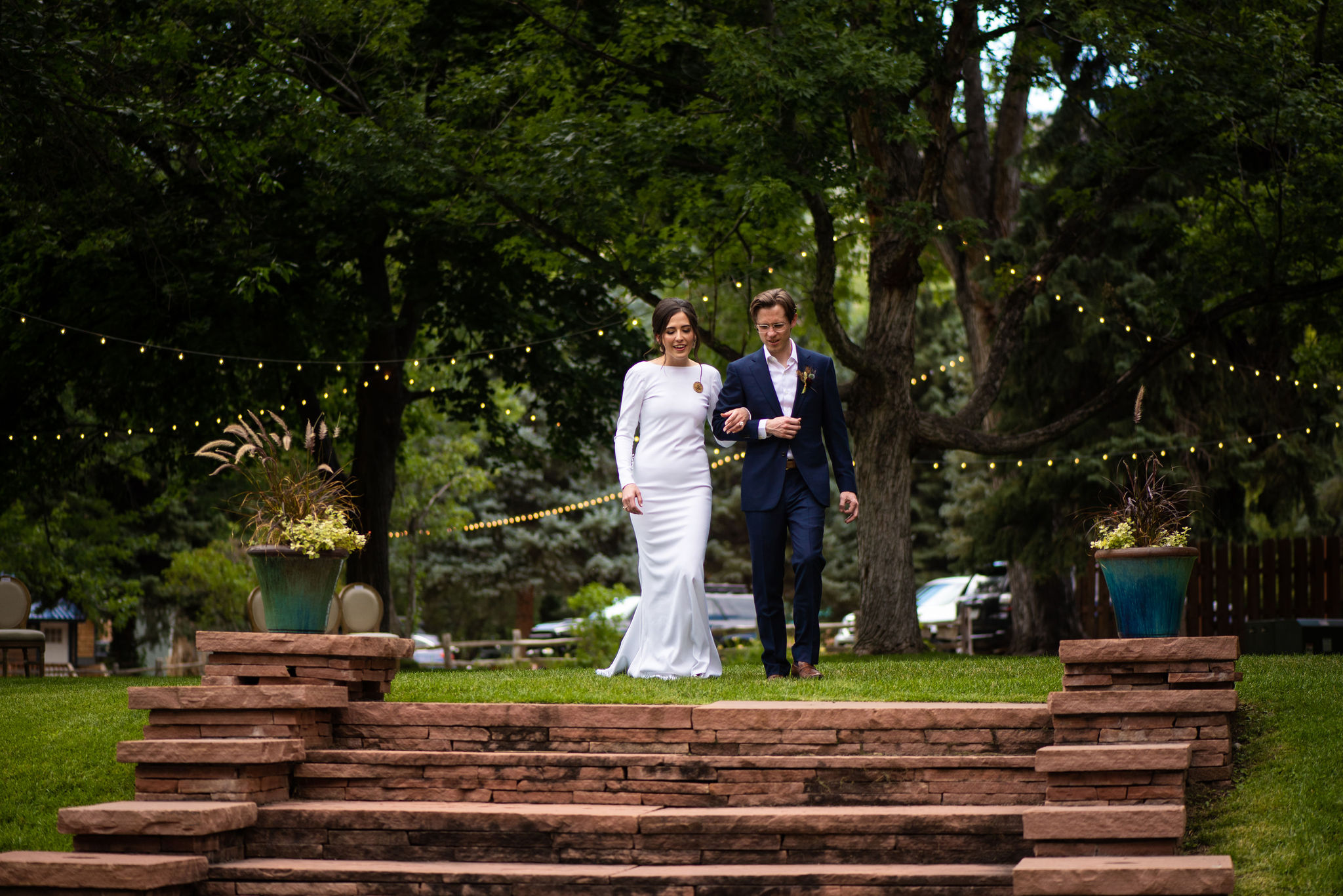 bride and groom walk down steps at colorado wedding venue that has lodging