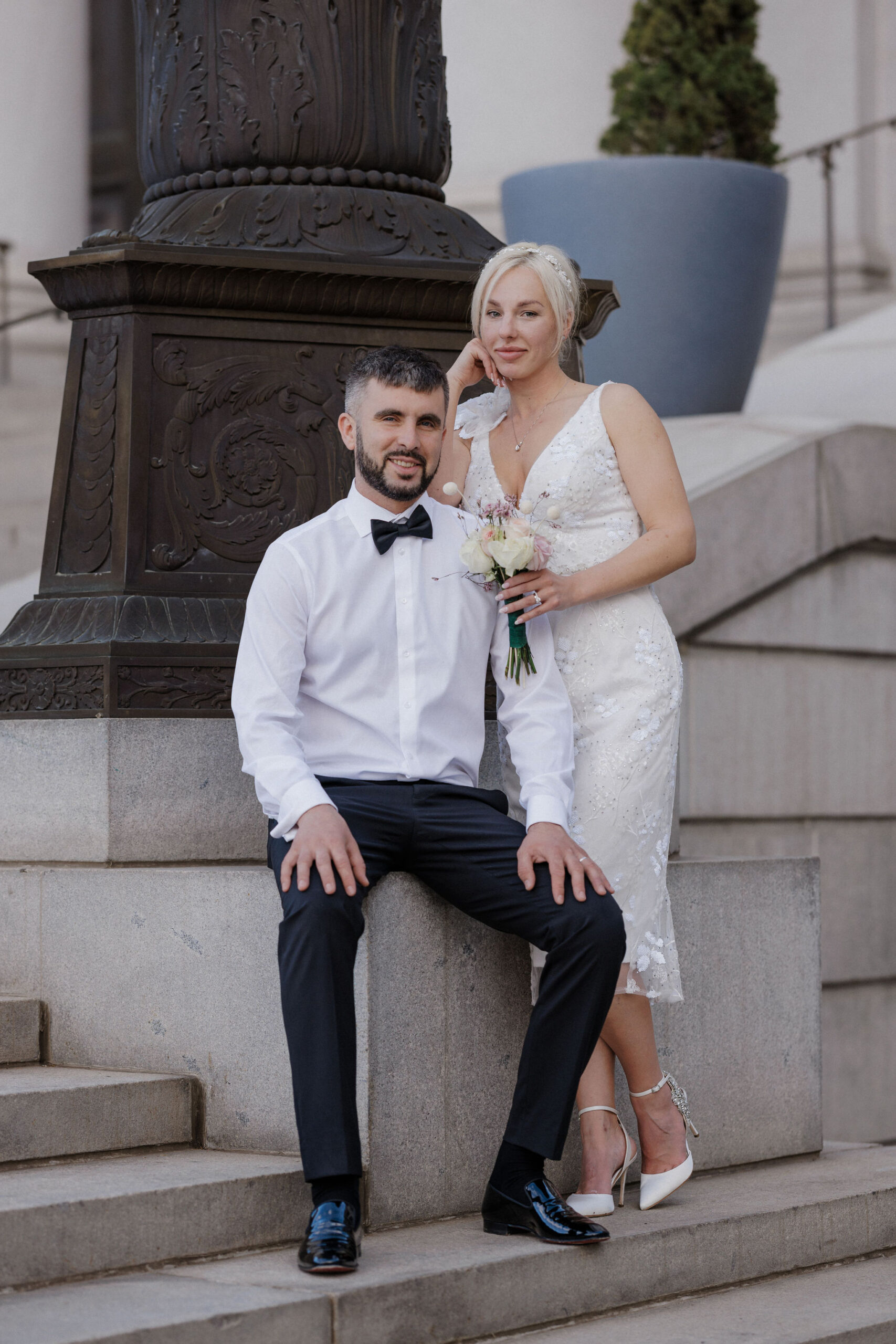bride and groom lean on steps during  denver courthouse elopement