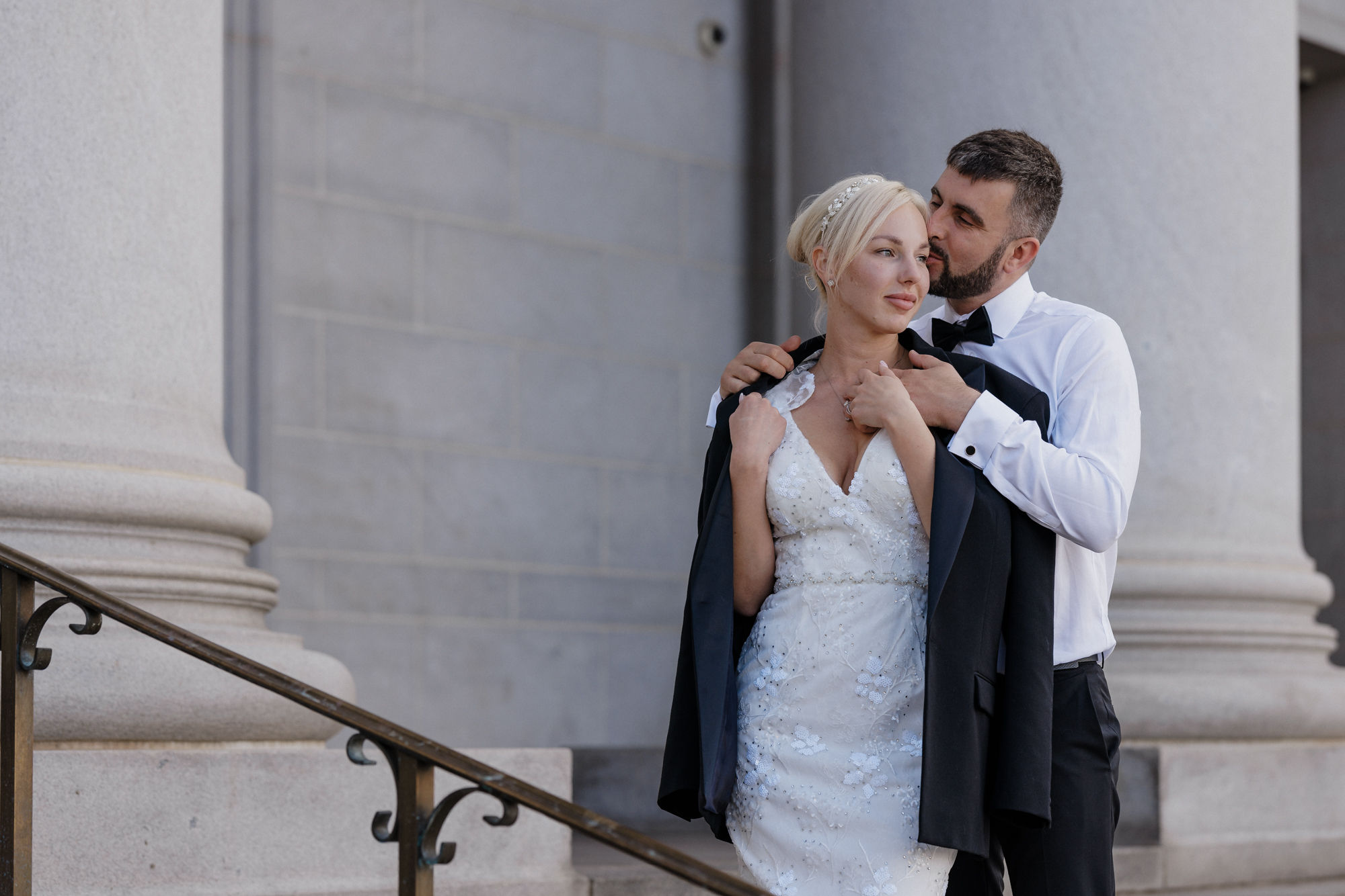 Why Renew Your Wedding Vows? Ideas, Reasons, + How-To: groom kisses brides head and puts jacket on her shoulders at denver courthouse