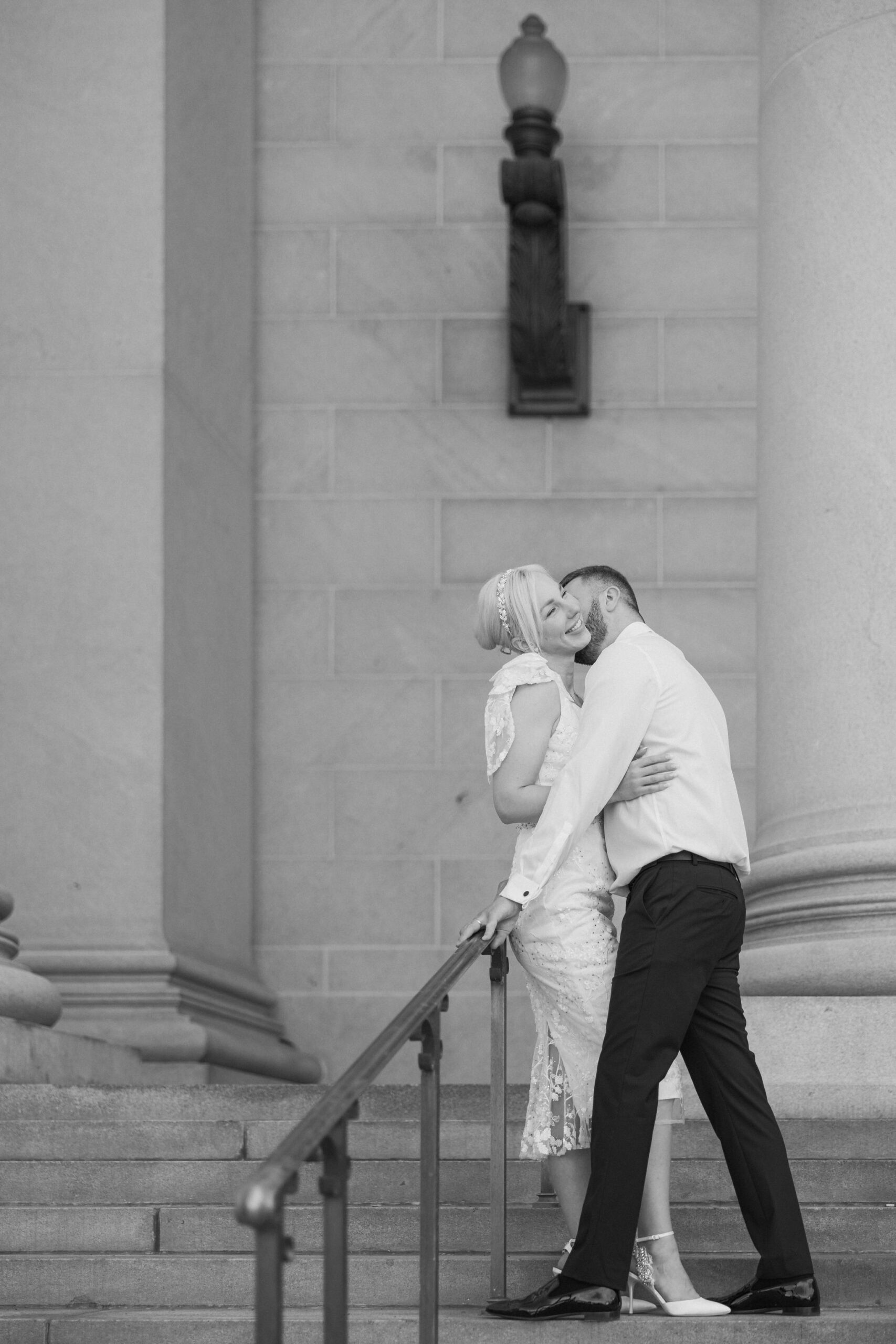 bride and groom pose for wedding photos at denver district court during elopement.