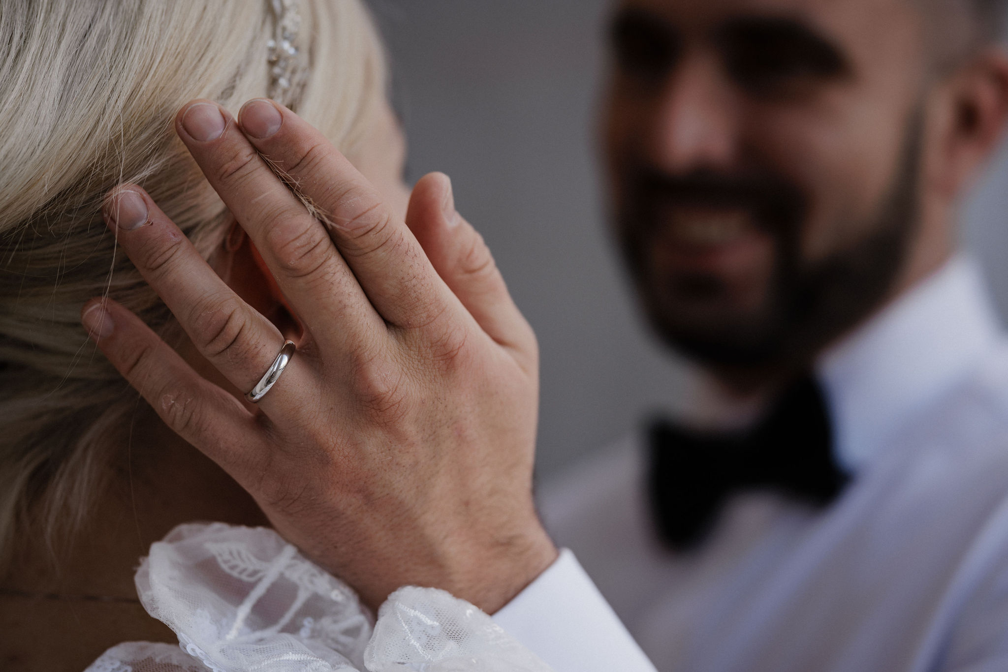 groom puts brides hair behind her ear during colorado elopement photos