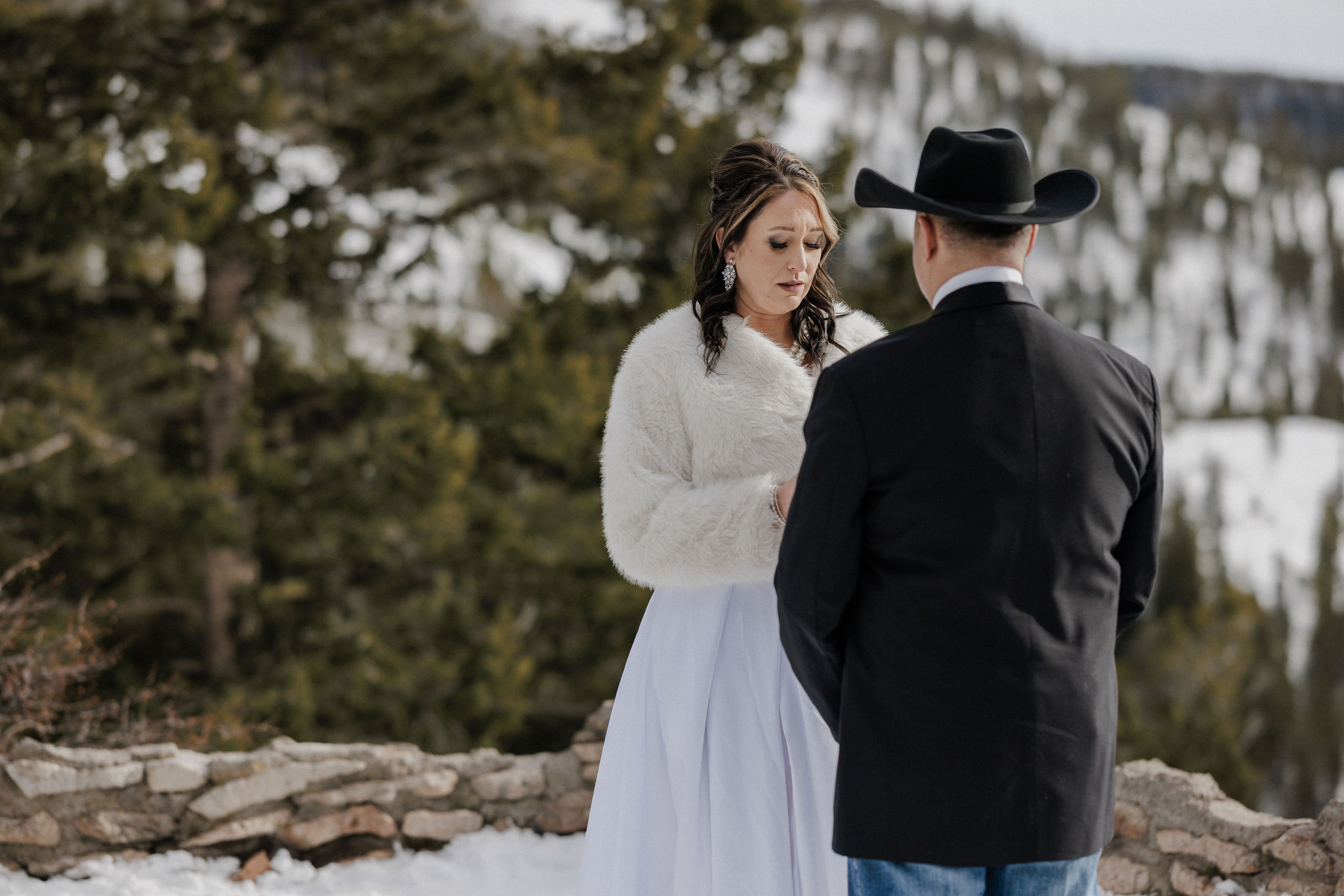 Why Renew Your Wedding Vows? Ideas, Reasons, + How-To: bride and groom read wedding vows in the colorado mountains