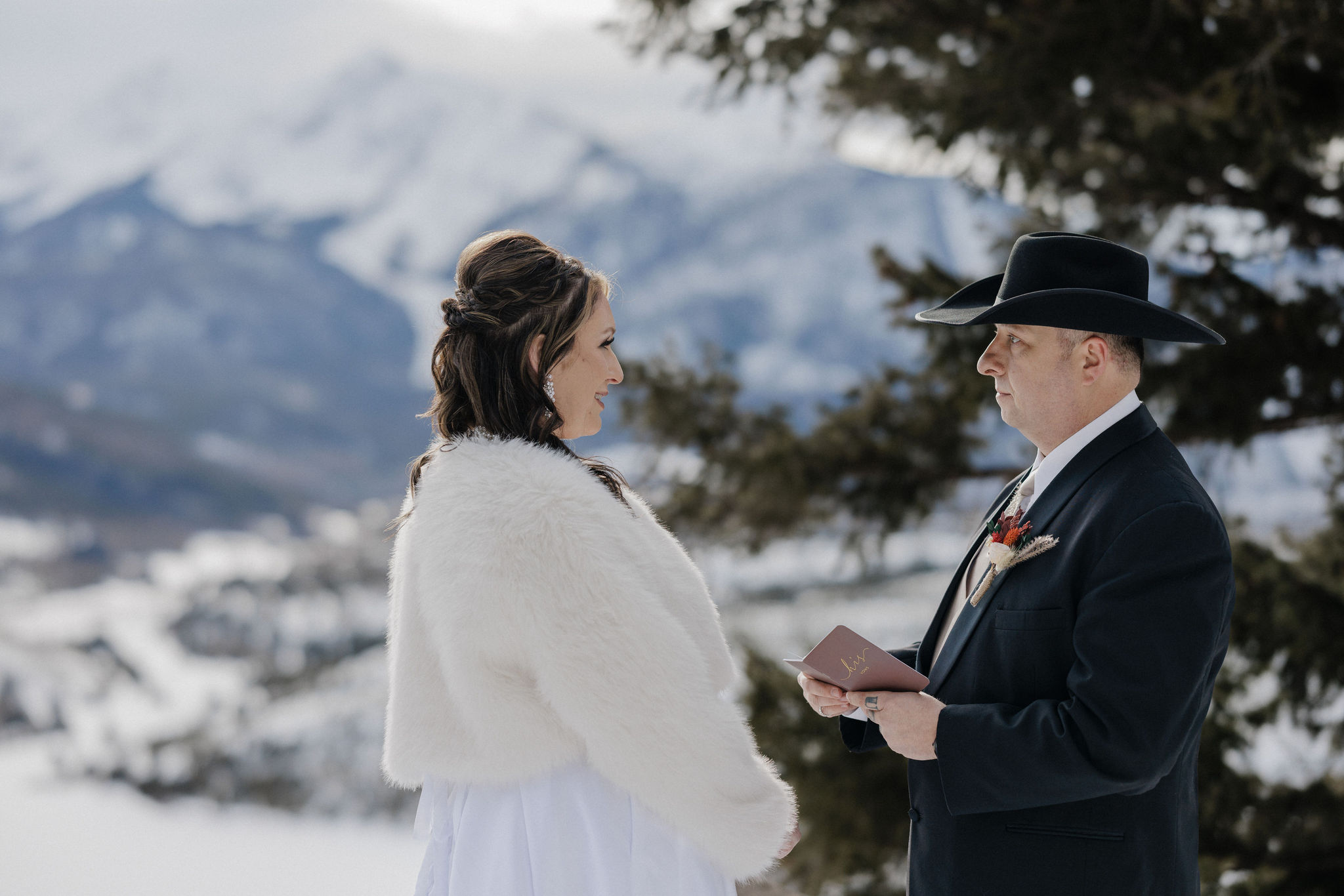 Why Renew Your Wedding Vows? Ideas, Reasons, + How-To: bride and groom say wedding vows during colorado mountain elopement