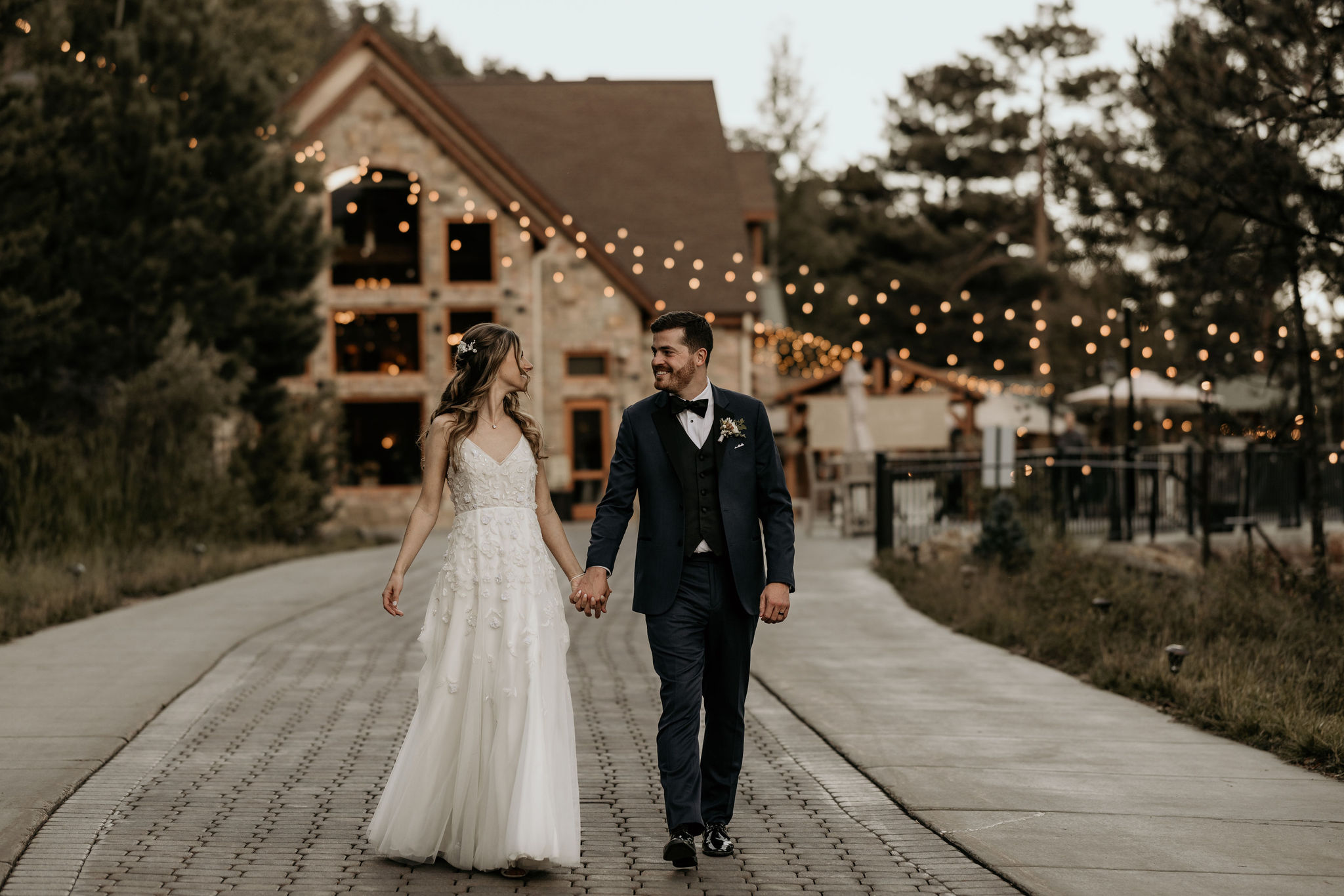 bride and groom walk down path at wedding venue
