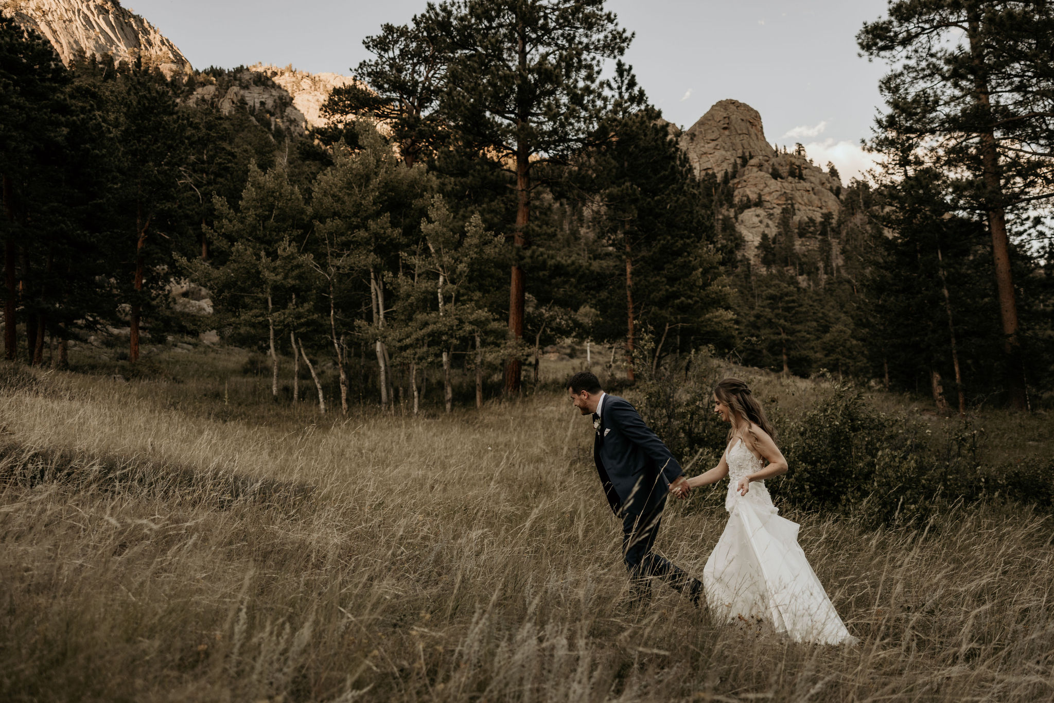 bride and groom walk up mountain to accommodation at colorado micro wedding venue
