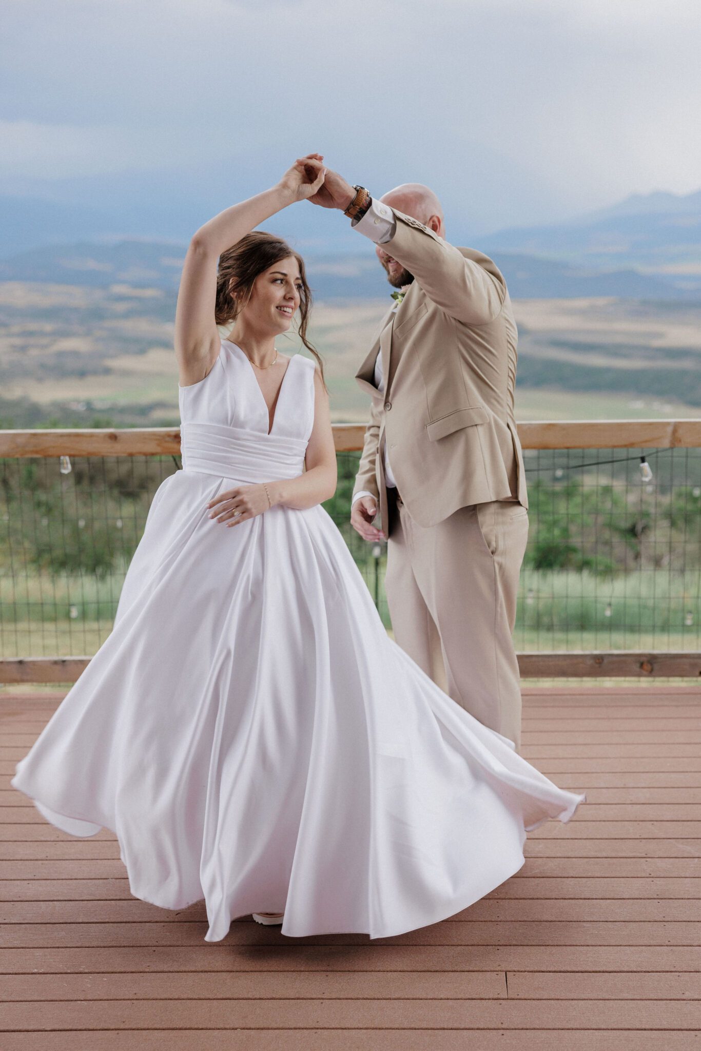 bride and groom dance on the deck of their micro wedding lodging in colorado