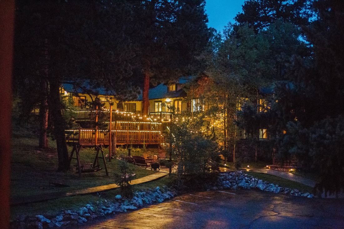 micro wedding venue lodging is lit up at night in the colorado mountains