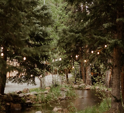 river with twinkle lights set up above it at colorado wedding venue with lodging.