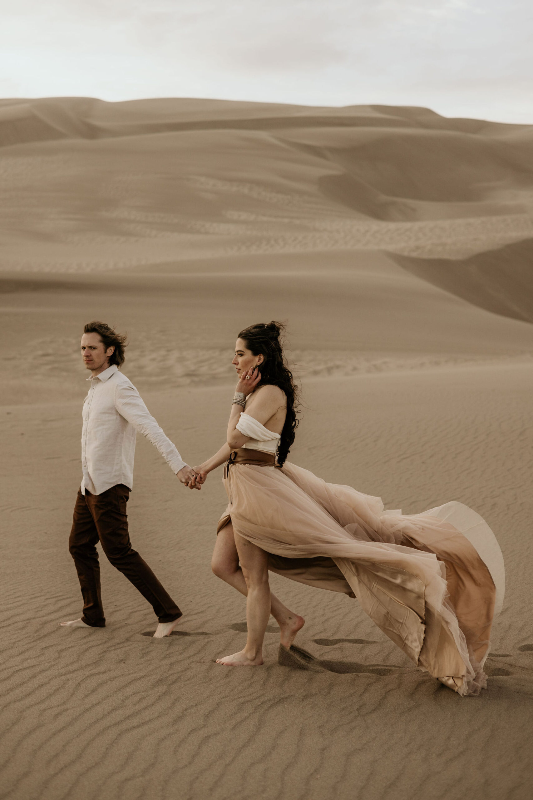 colorado wedding photographer poses for engagement photos in neutral clothing