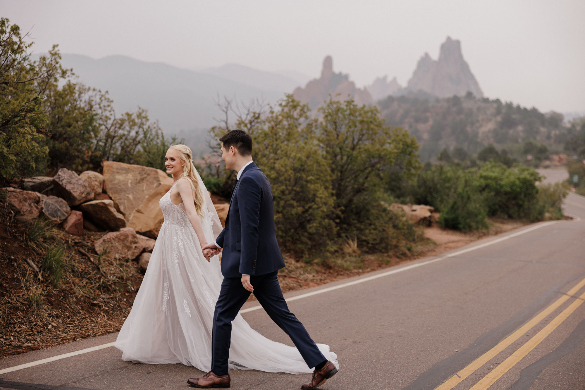 bride and groom walk around garden of the gods in colorado springs for micro wedding photos.