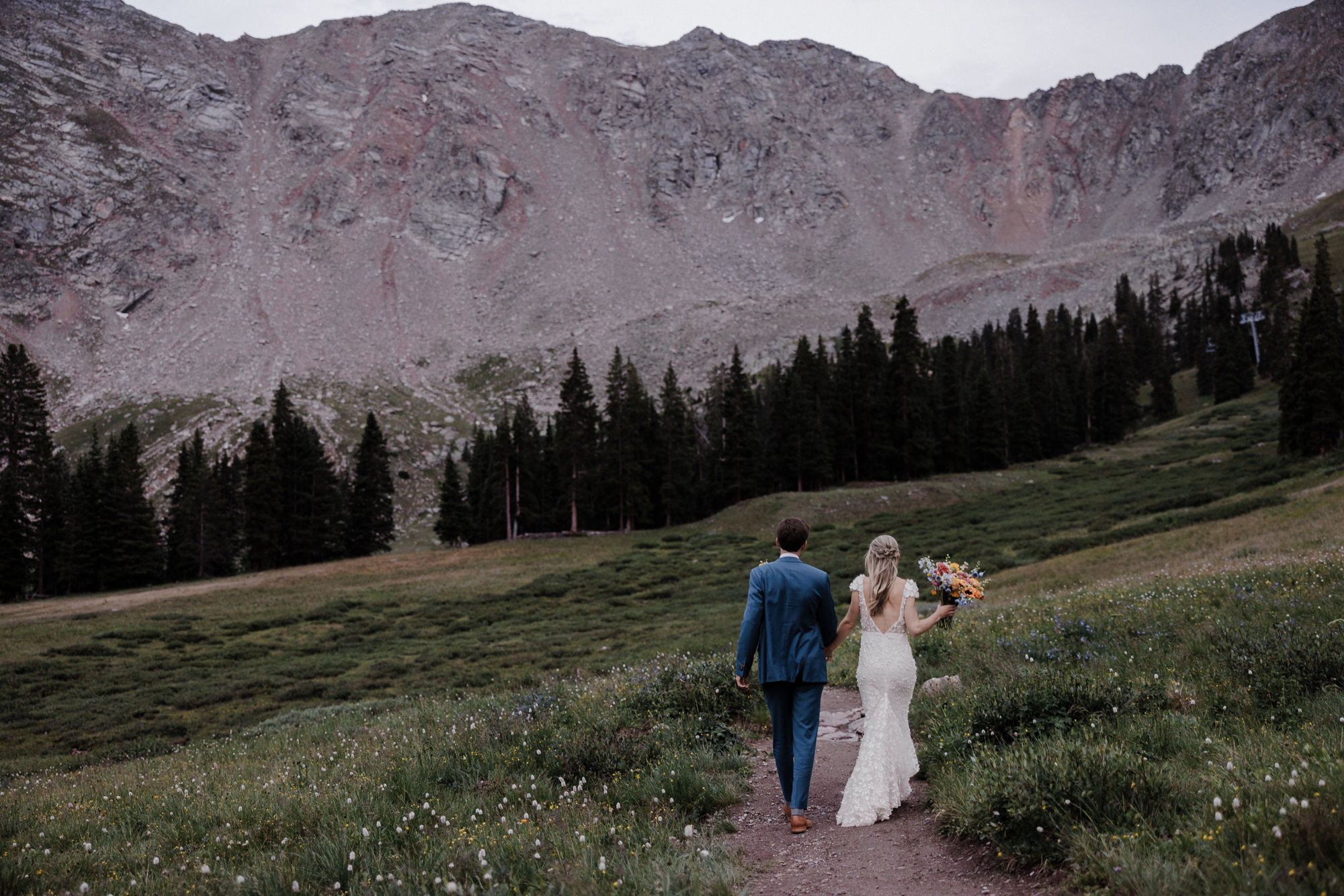after knowing what questions to ask wedding vendors, bride and groom take wedding photos in the colorado mountains