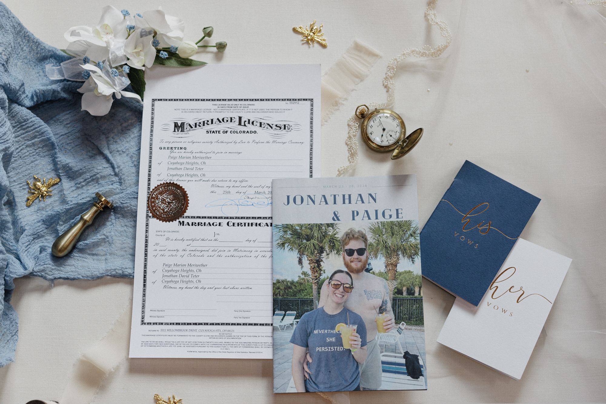 Flatlay photo of micro wedding details and Colorado marriage license.