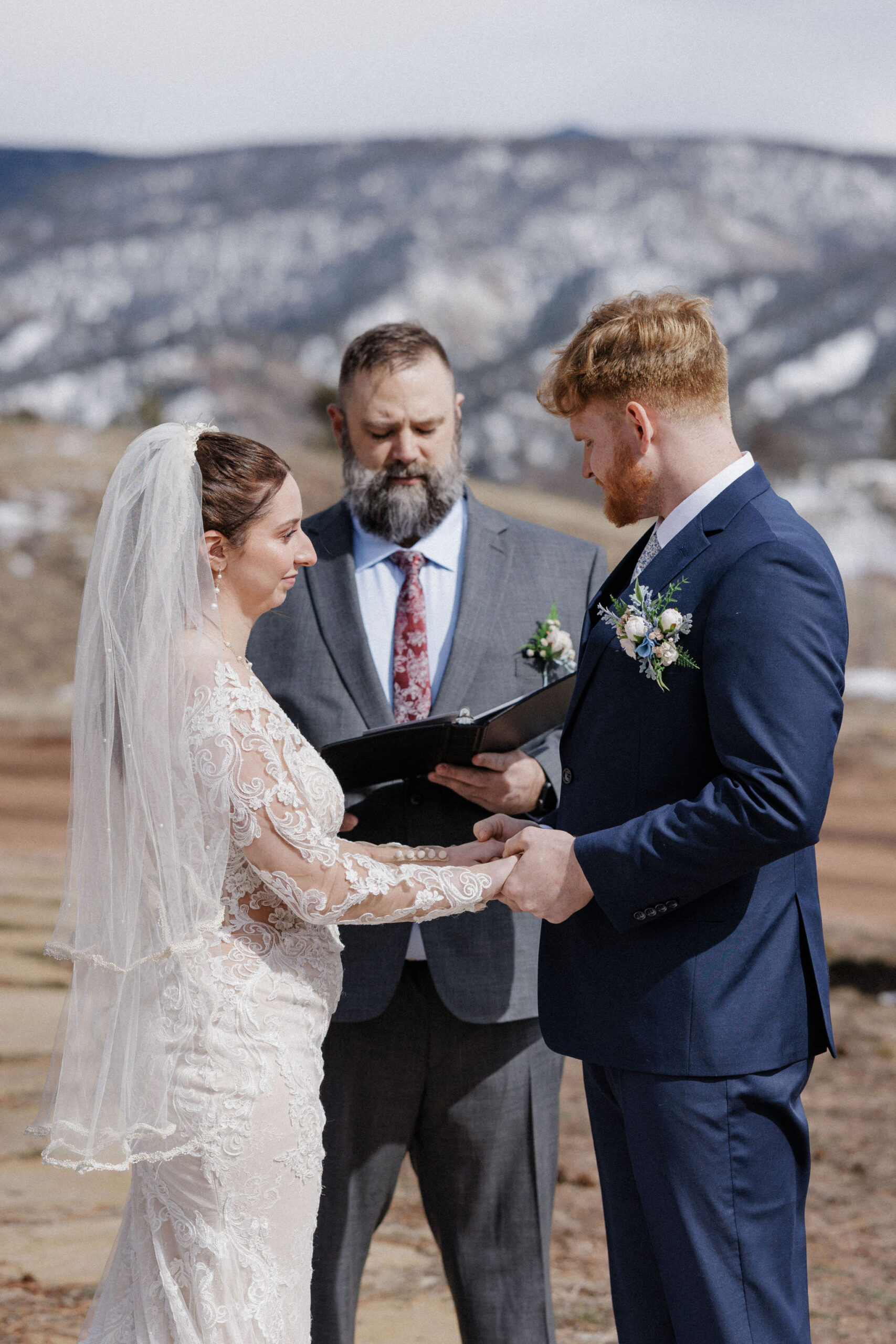 bride and groom stand  hand in hand during airbnb micro wedding in colorado
