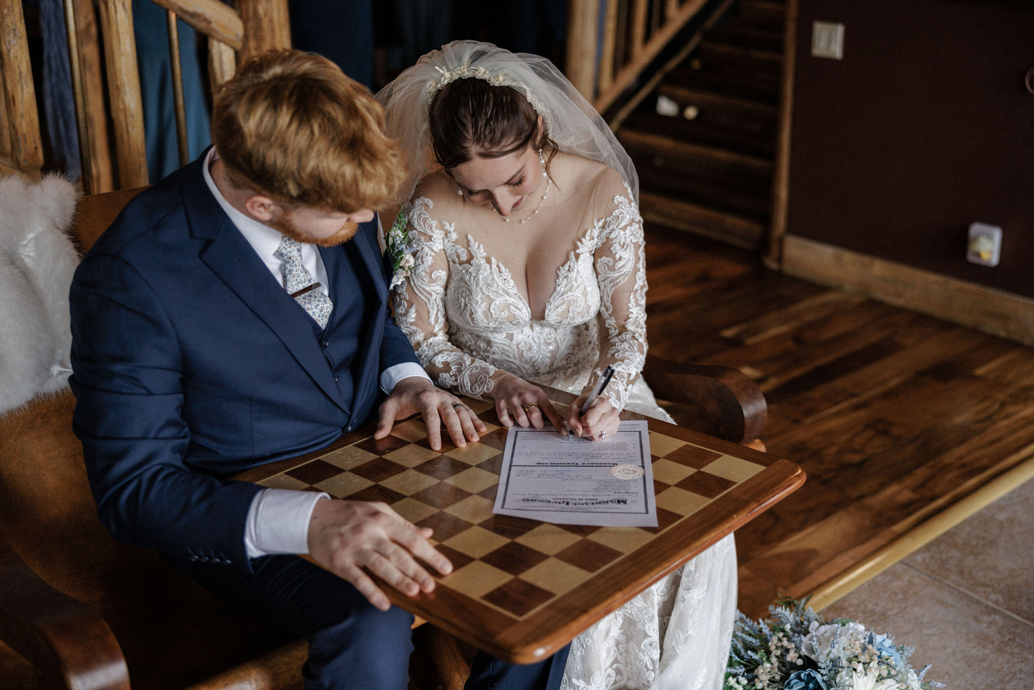 bride and groom sign marriage license at colorado airbnb