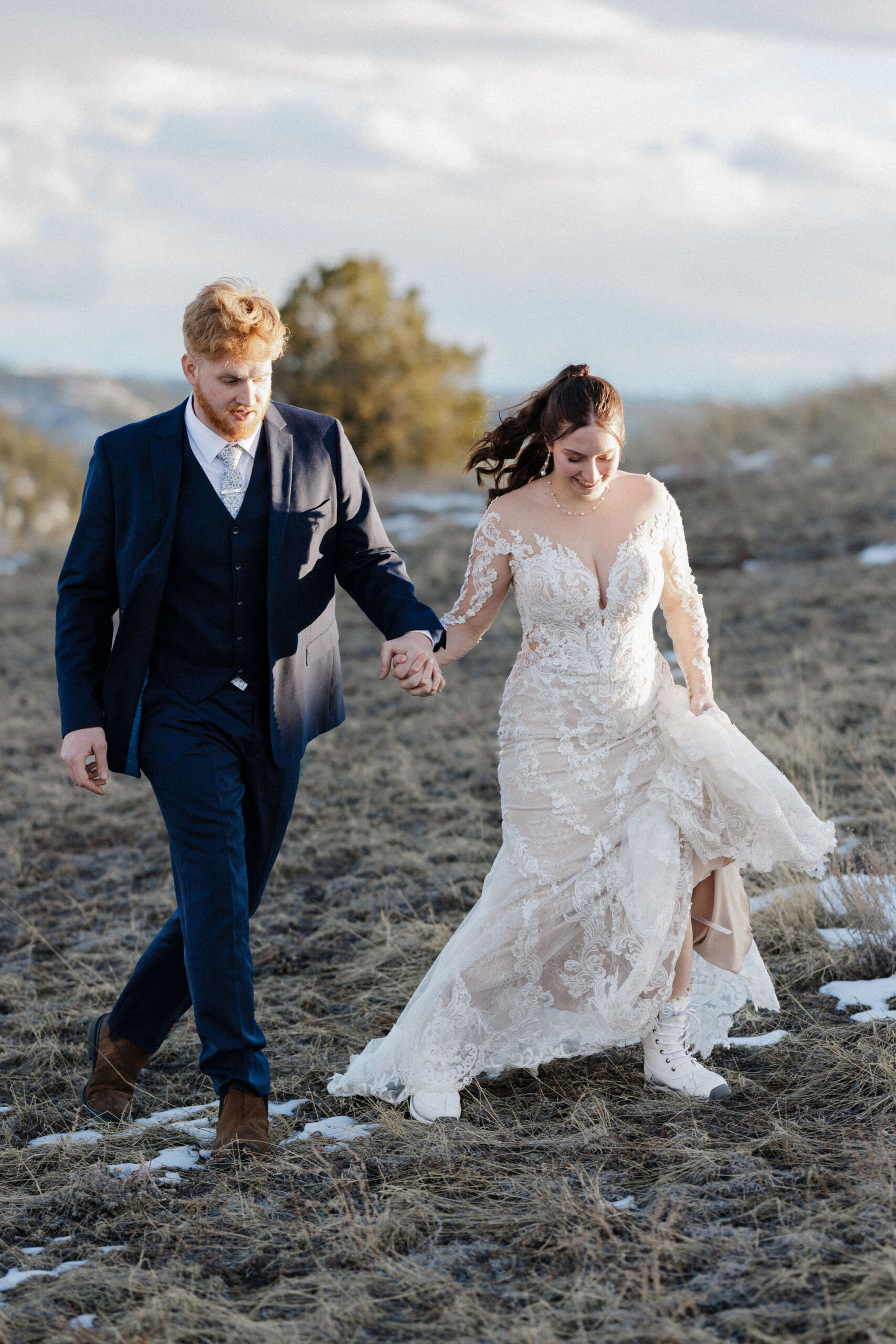 bride and groom walk around mountain during colorado micro wedding