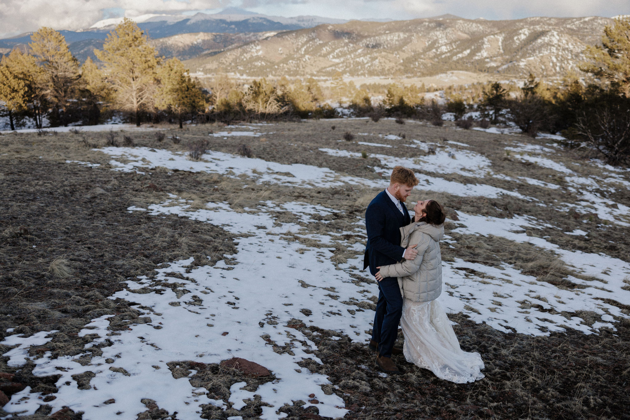 bride and groom hug on mountain during colorado micro wedding at airbnb