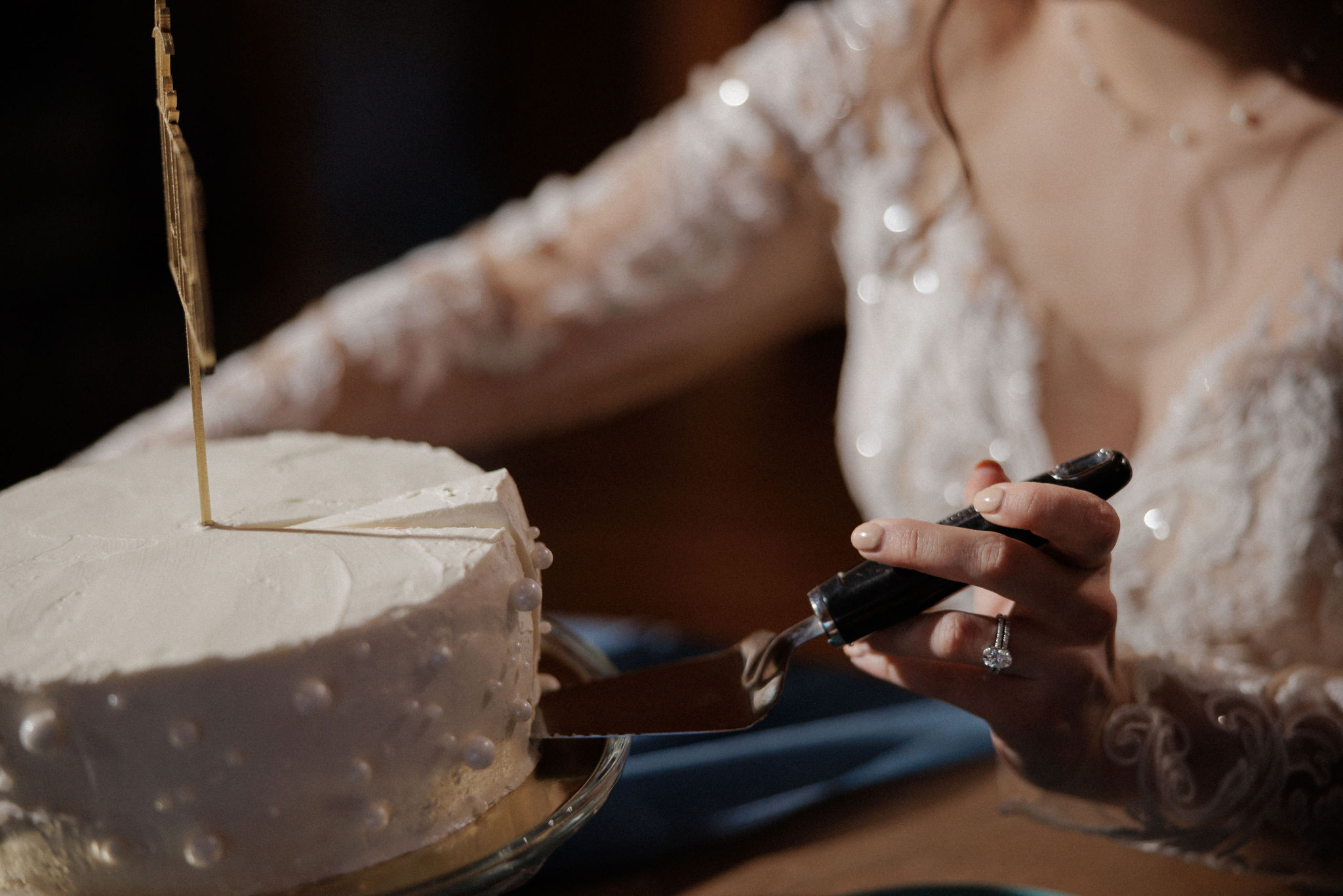 bride cuts wedding cake