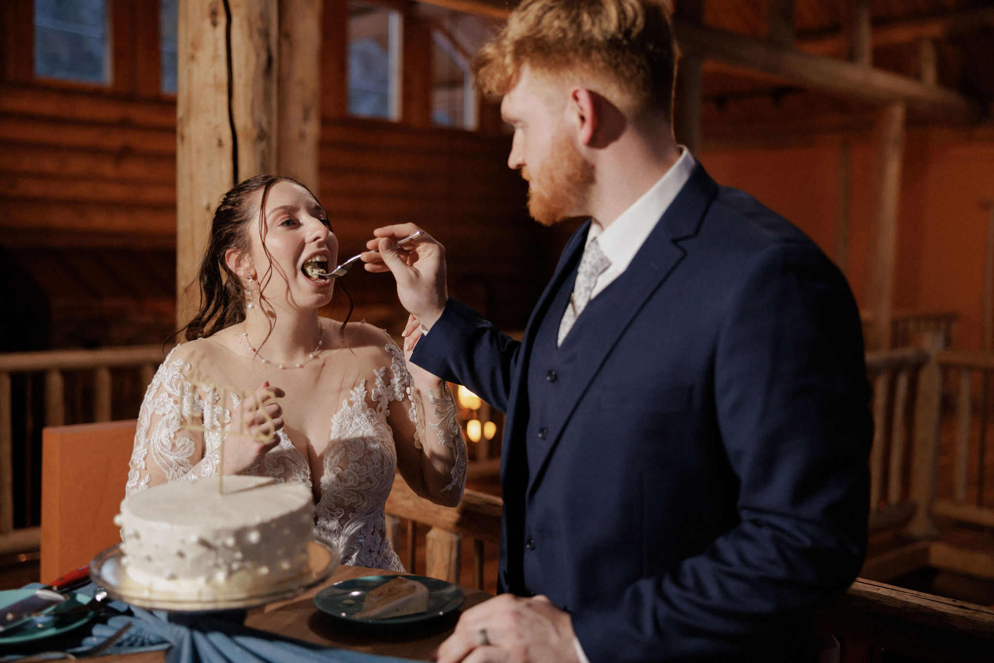 groom feeds bride a bite of wedding cake